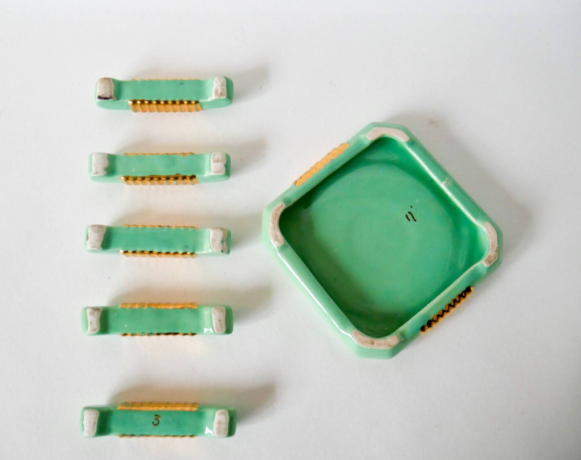 set of coasters and knife holders in mint green and gold art deco ceramic 1930