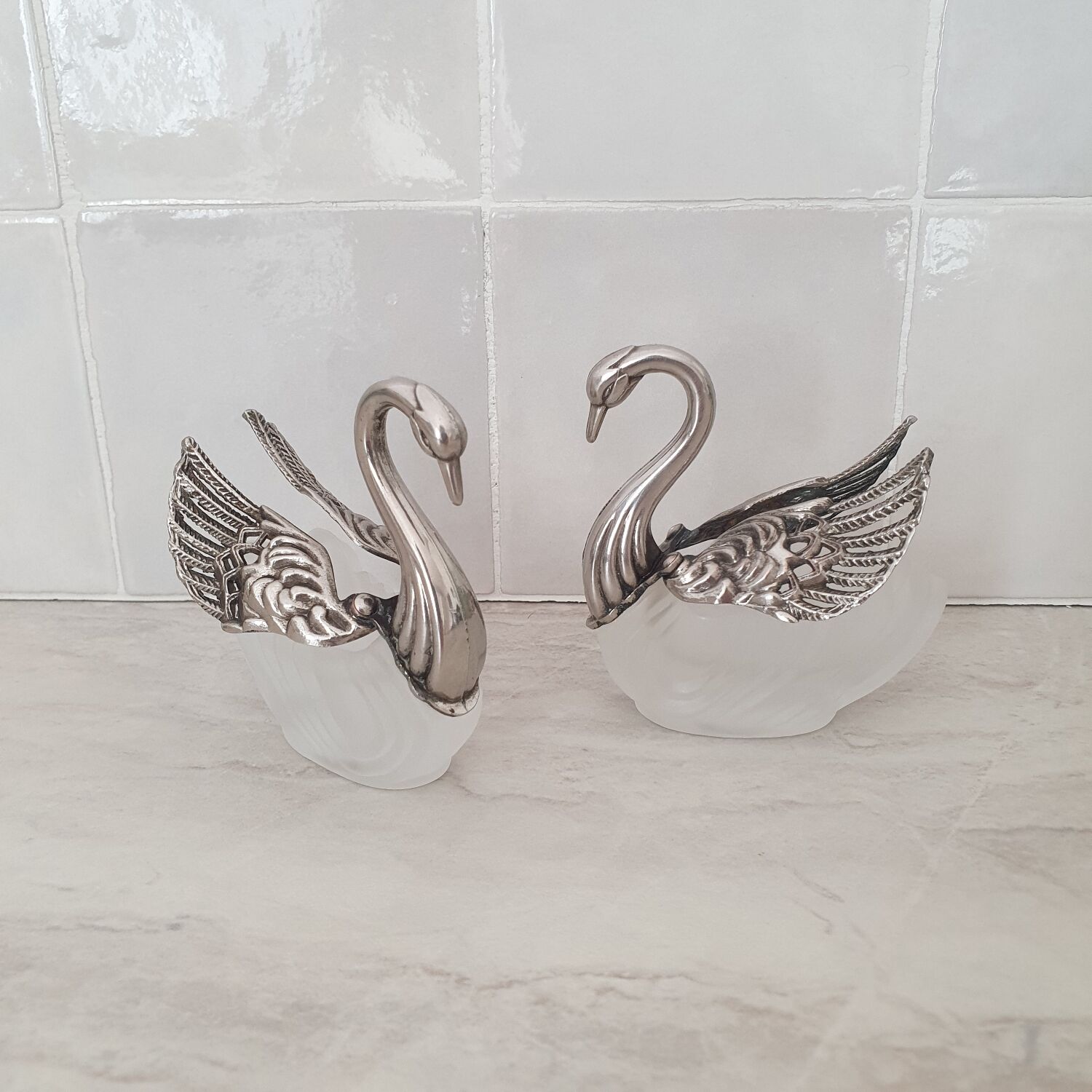 Two frosted glass swan salt cellars with silver plating.