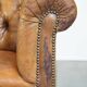 Antique, characteristic sheepskin chesterfield club chair on wheels