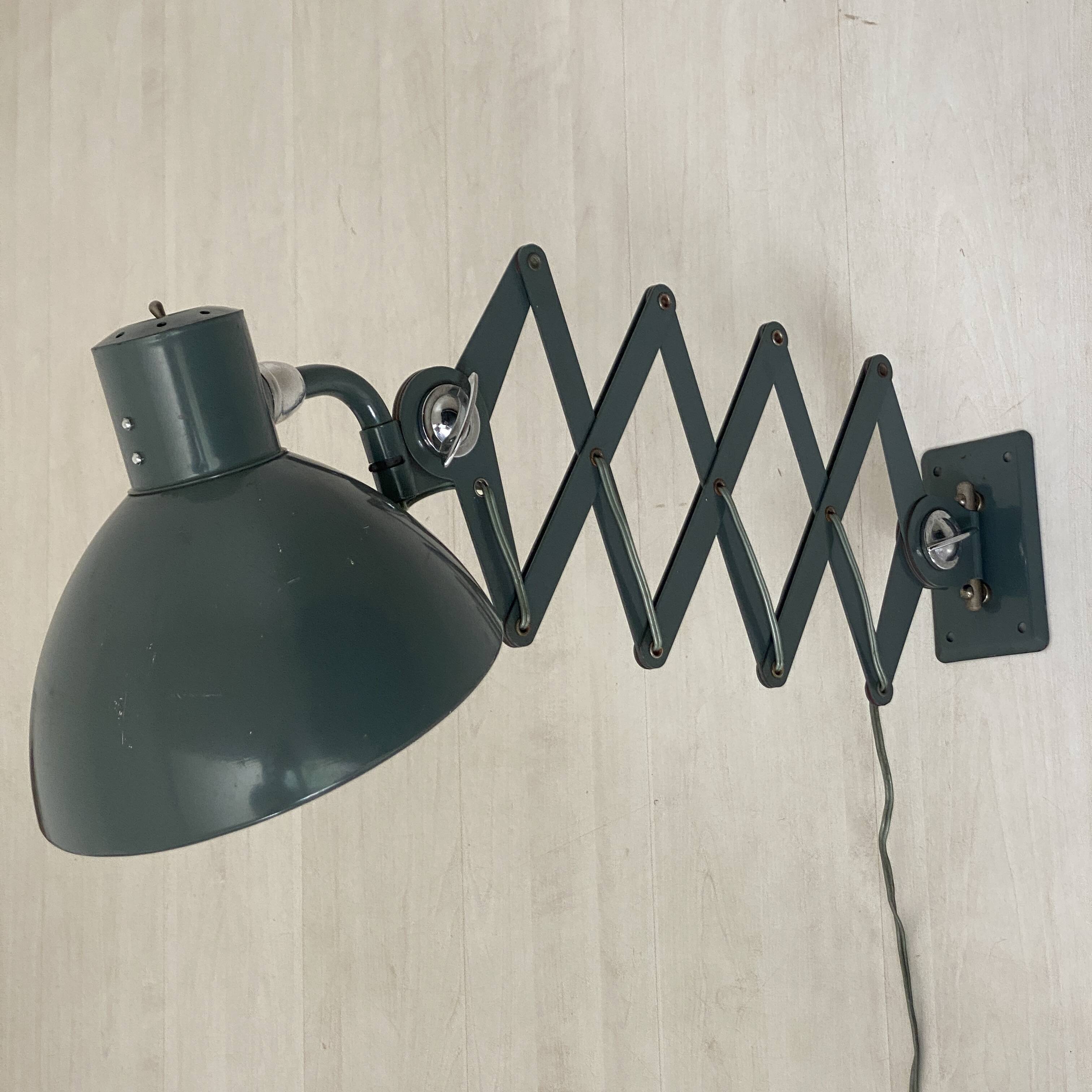 Vintage 1950s green lacquered sheet metal workshop wall light with accordion arm.