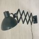 Vintage 1950s green lacquered sheet metal workshop wall light with accordion arm.