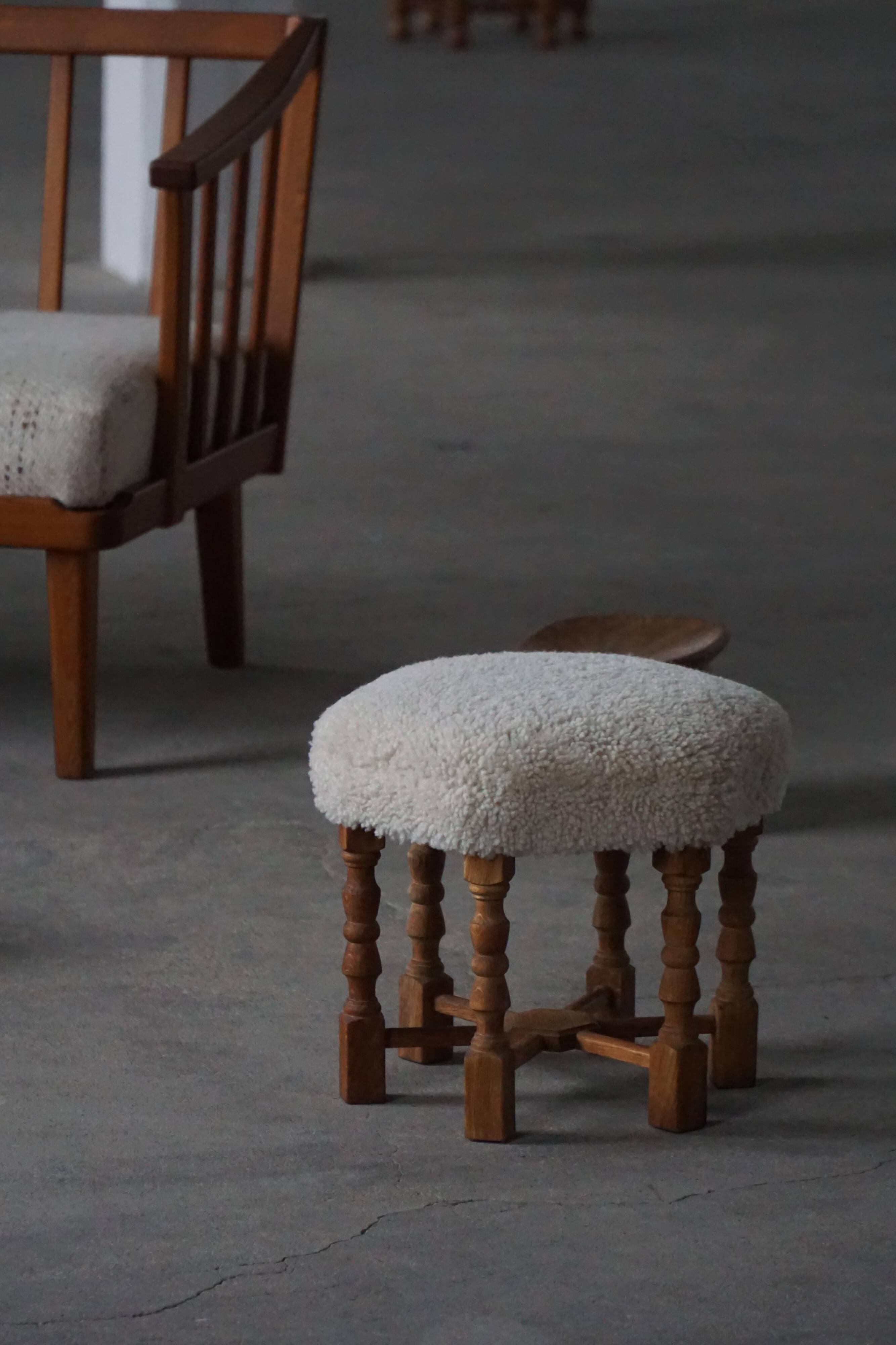 Pair of mid-century Danish oak stools with shearling lambswool upholstery, 1950s.