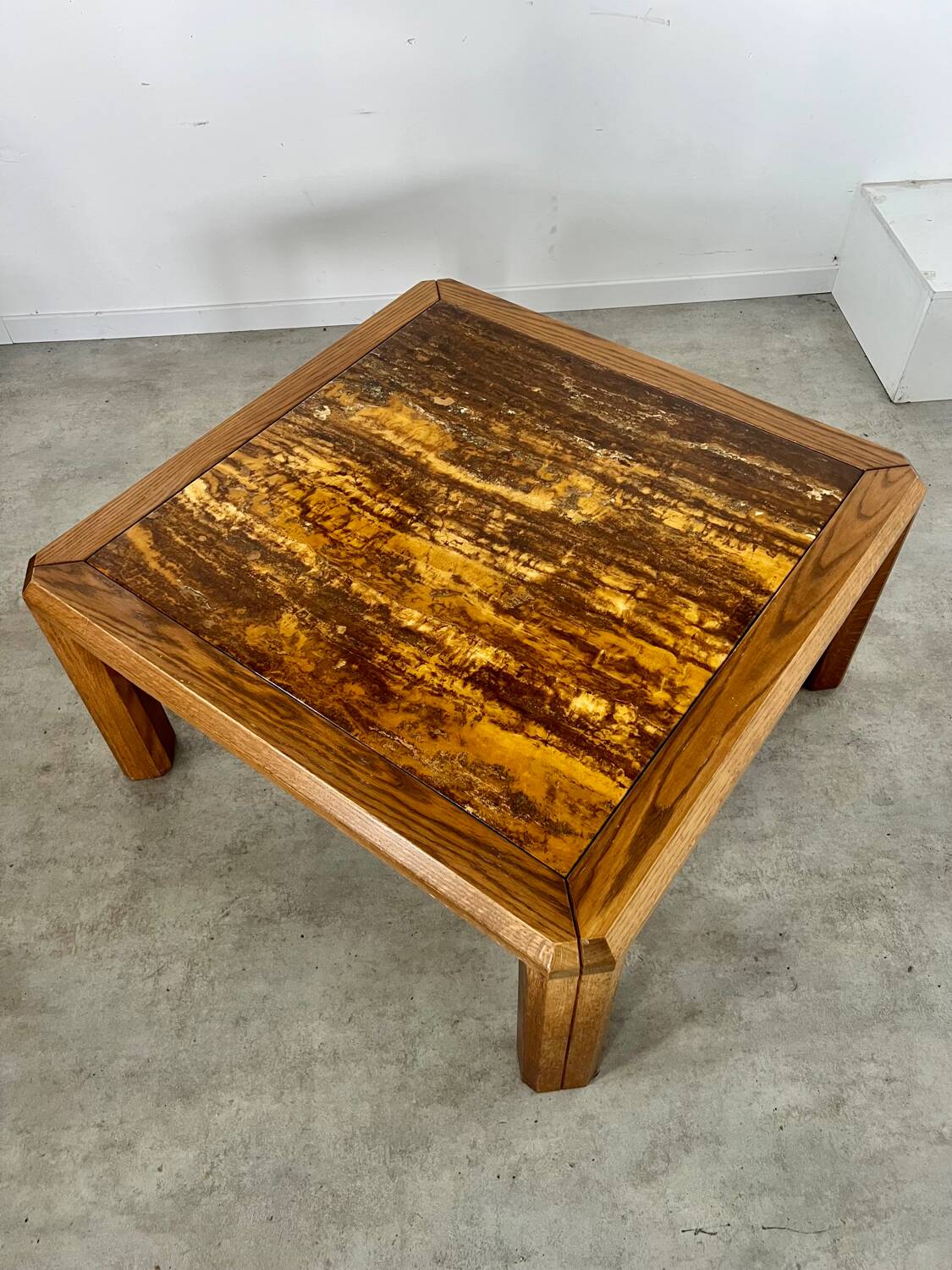 Old coffee table with golden marble top, 70s design, vintage wooden feet