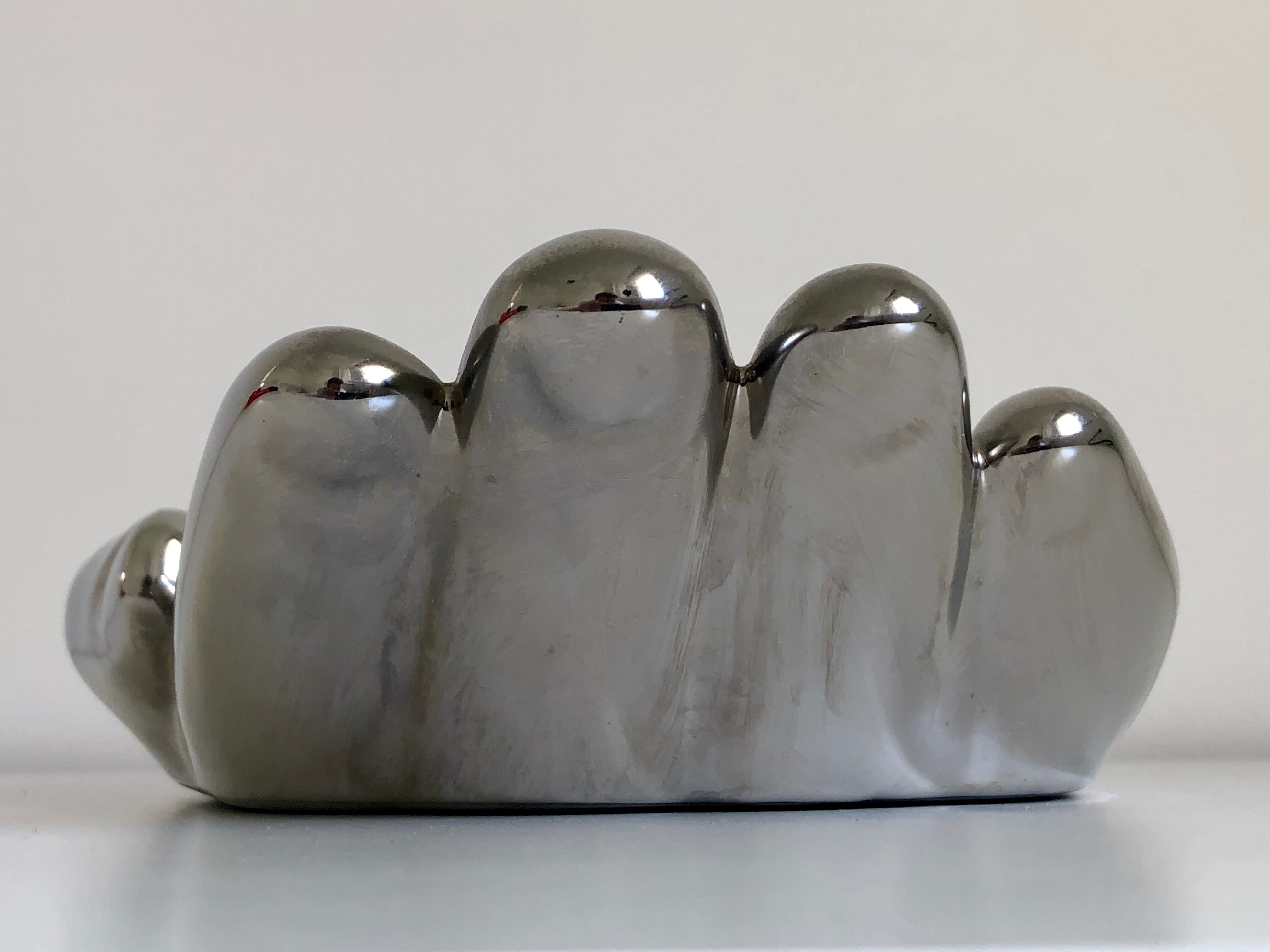 Empty silver chromed ceramic pocket in the shape of a large hand, 1980