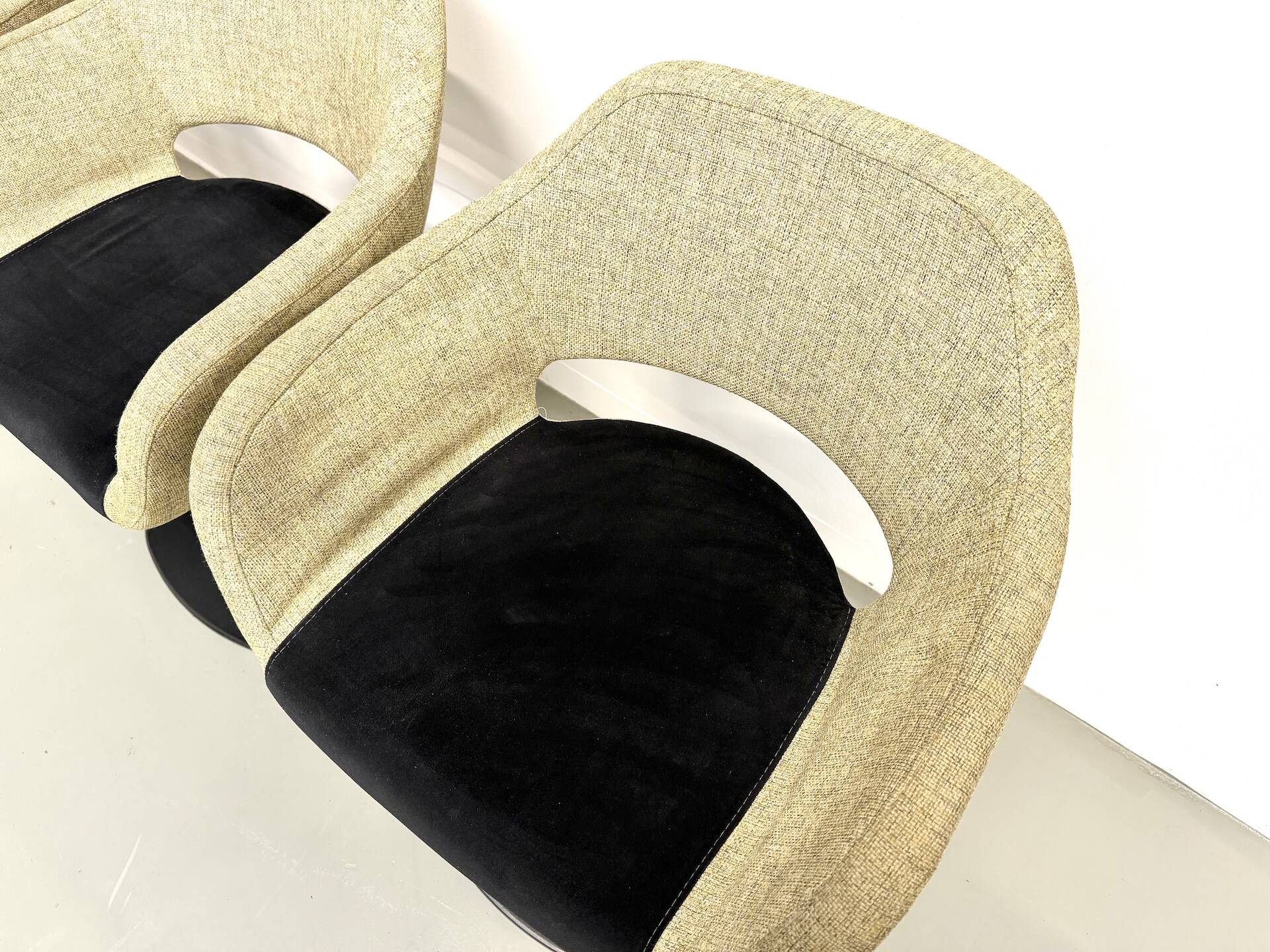 Series of six swivel chairs with an organic shell, patterned fabric and base.