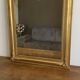 Late 19th century gilded mirror with decorated pediment. 125x70.