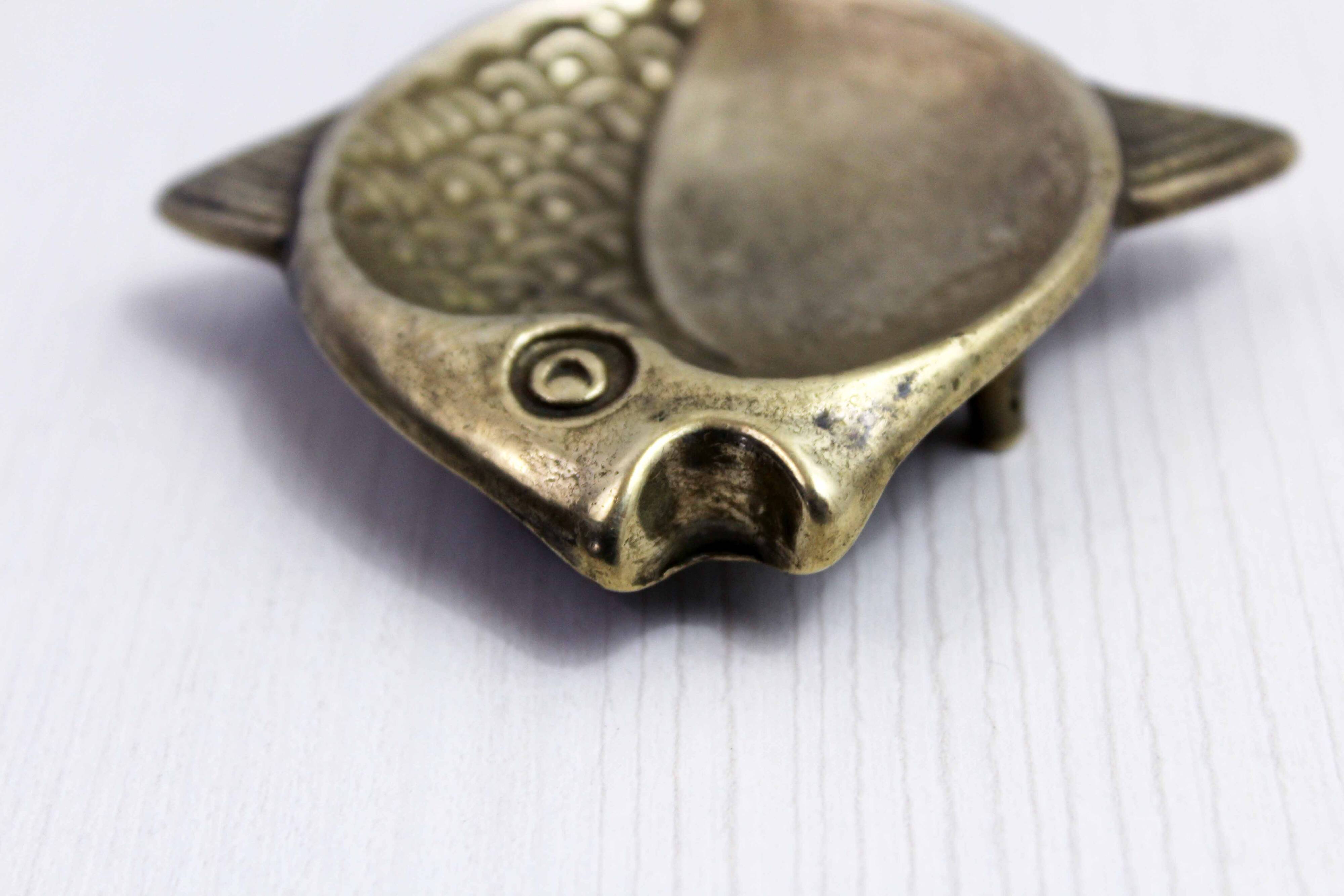 Vintage fish-shaped brass pocket emptier