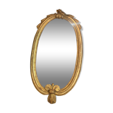 Oval mirror in gilded wood