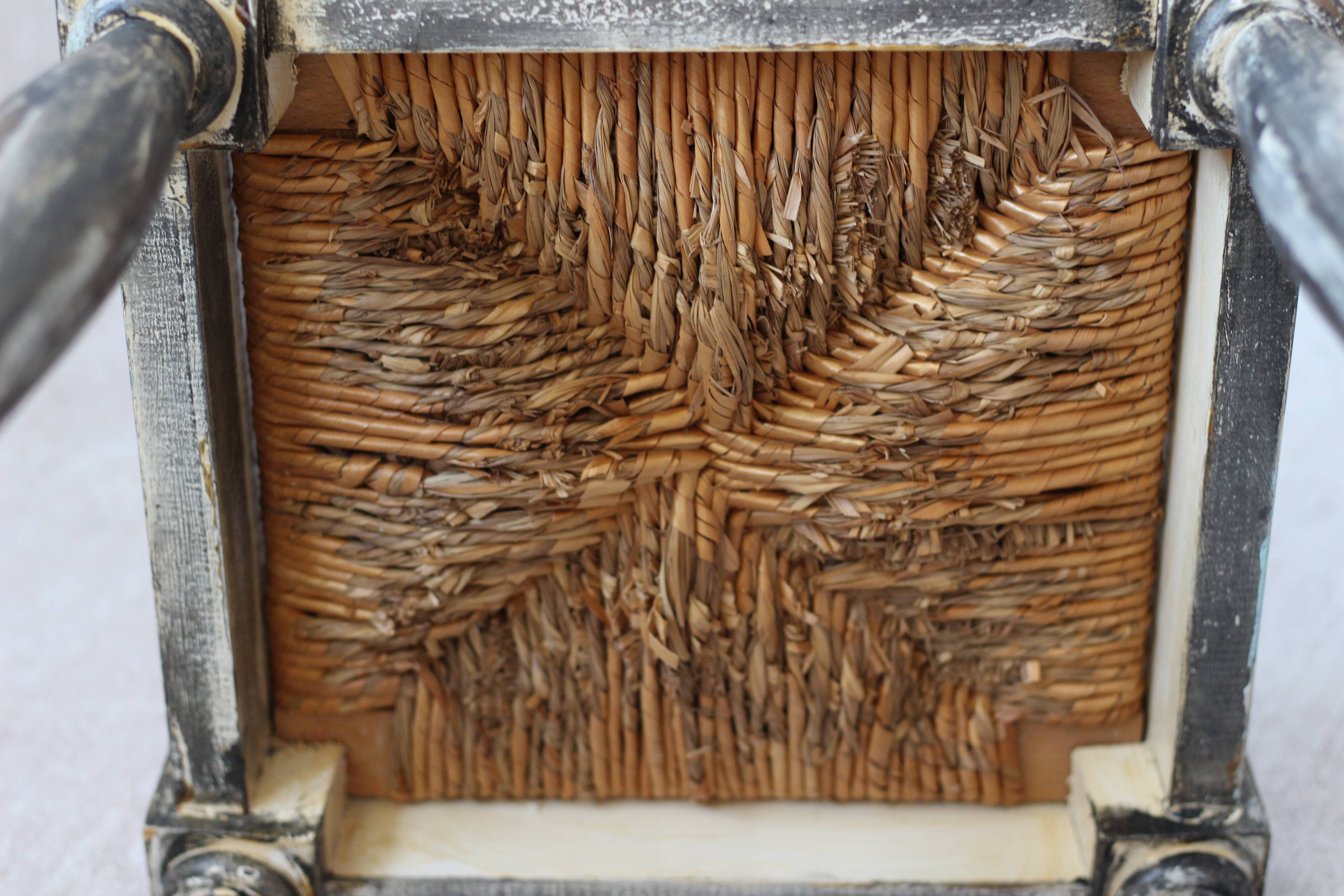 Patinated wooden stool with straw seat