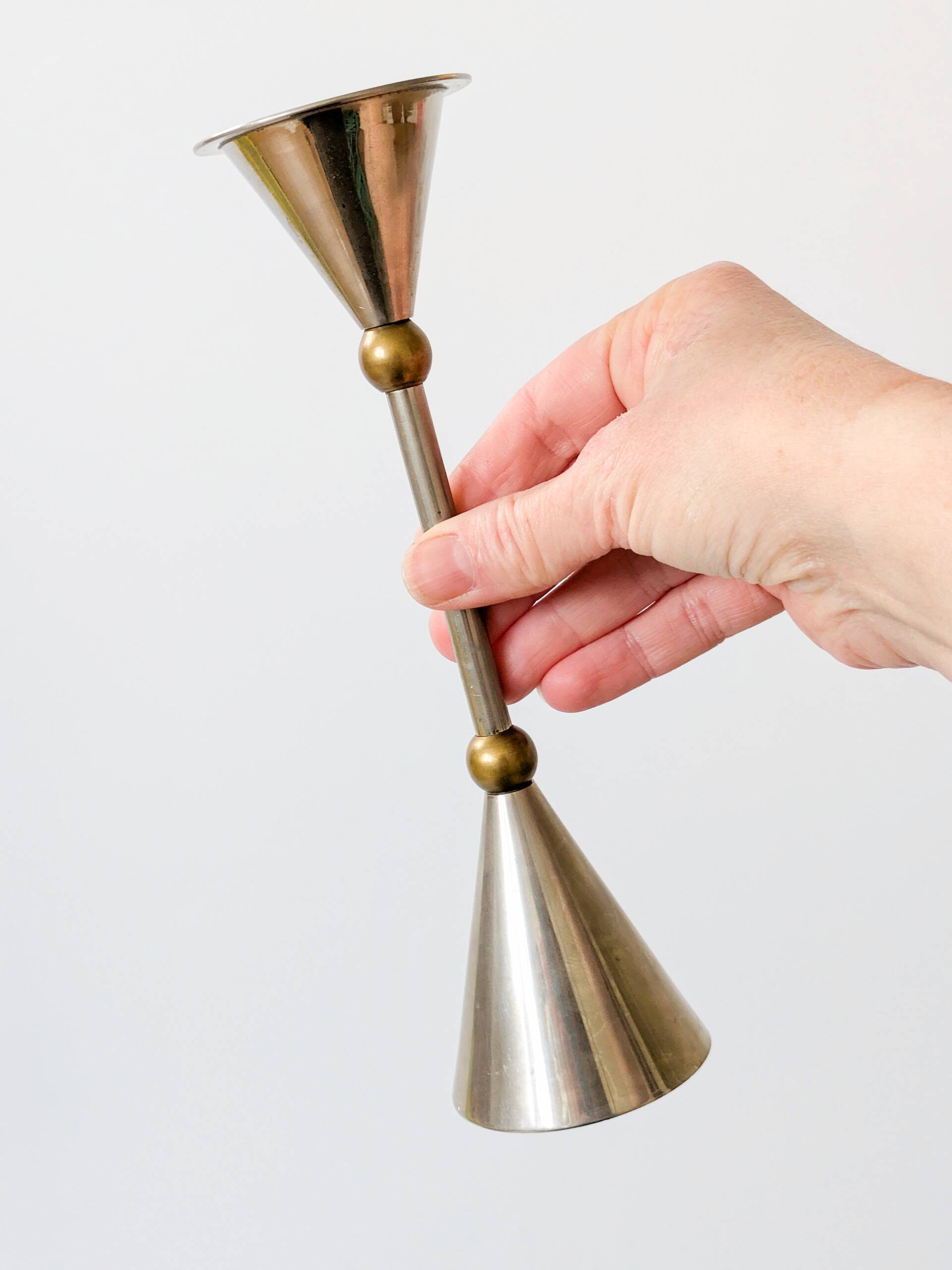 Pair of postmodern candlesticks in Memphis style made of steel and brass.