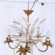 Vintage wrought iron chandelier decorated with golden and beige reeds