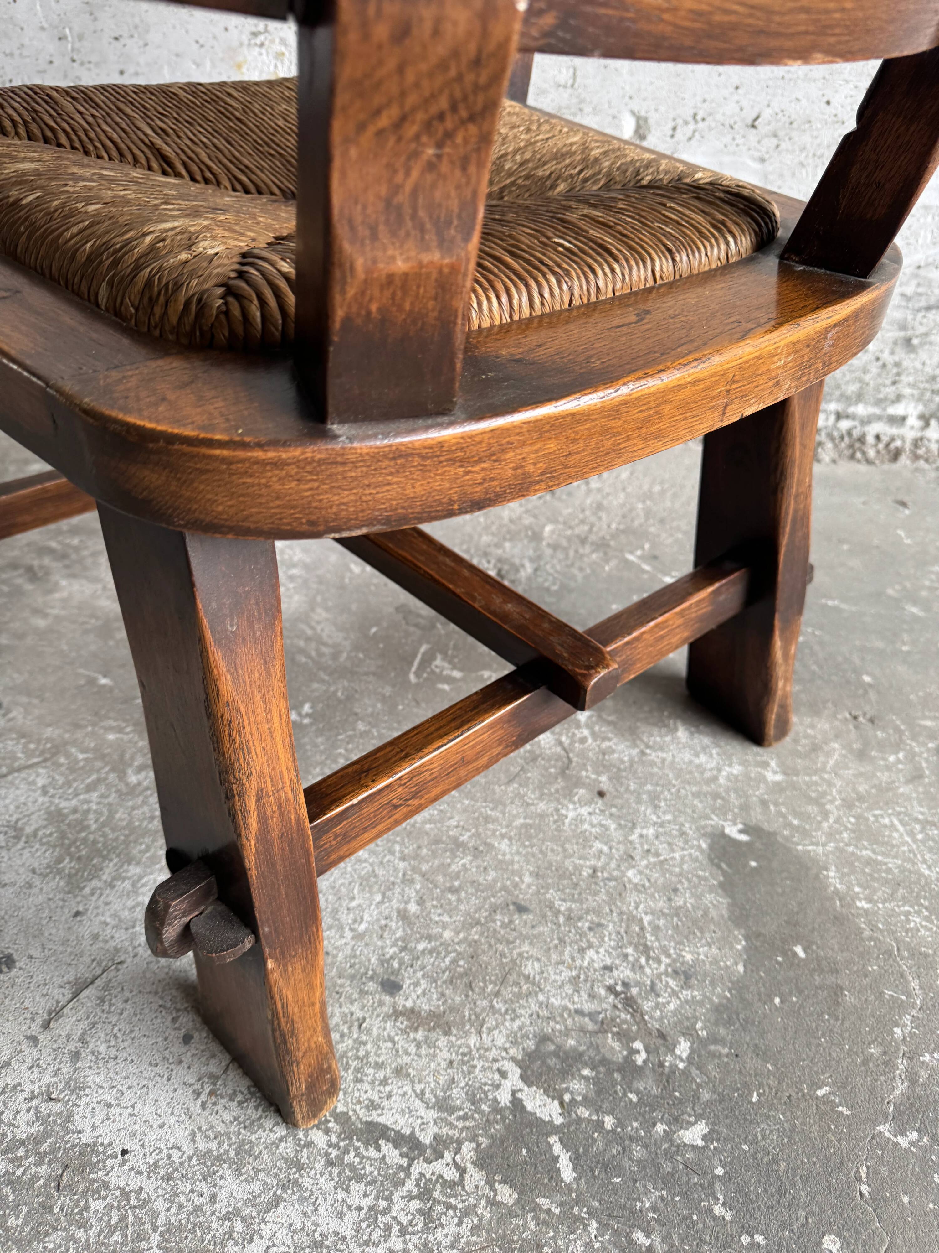 Brutalist dark brown solid wood armchair with natural rattan seat and cognac leather back