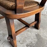 Brutalist dark brown solid wood armchair with natural rattan seat and cognac leather back