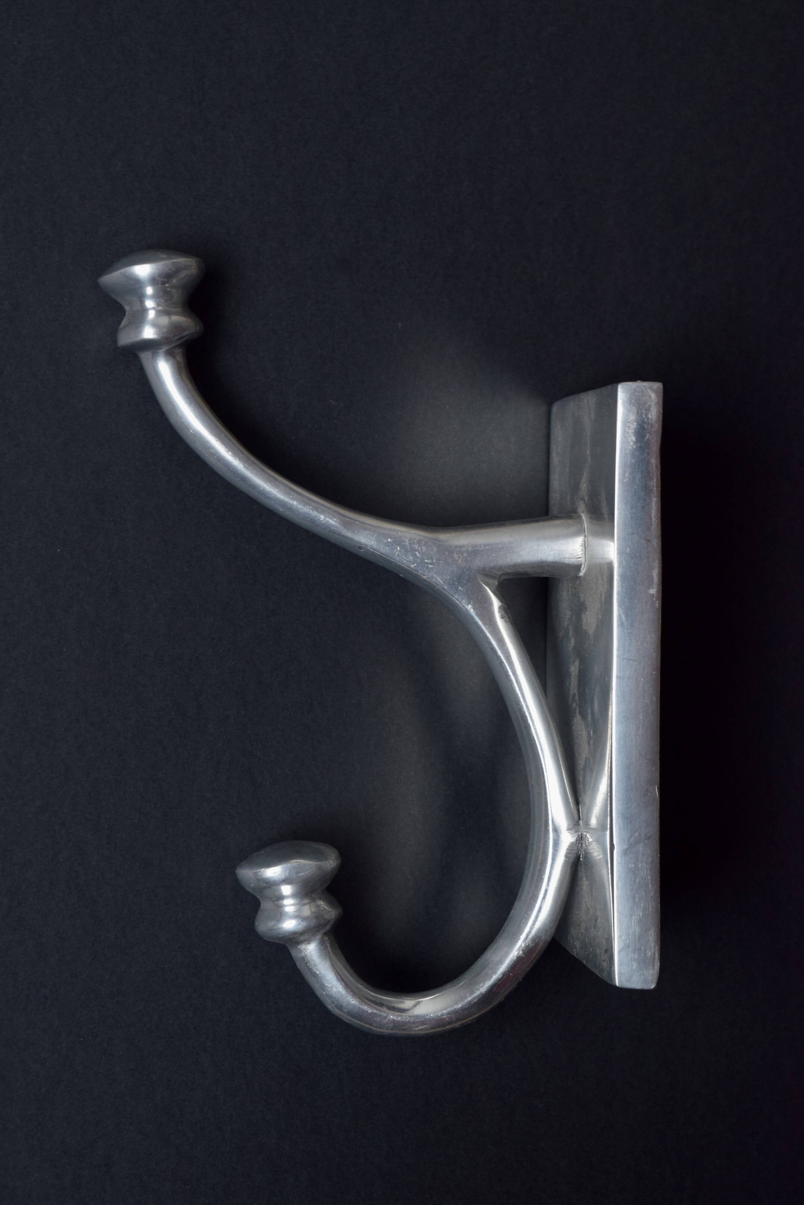 Pair of vintage cast aluminum coat hooks