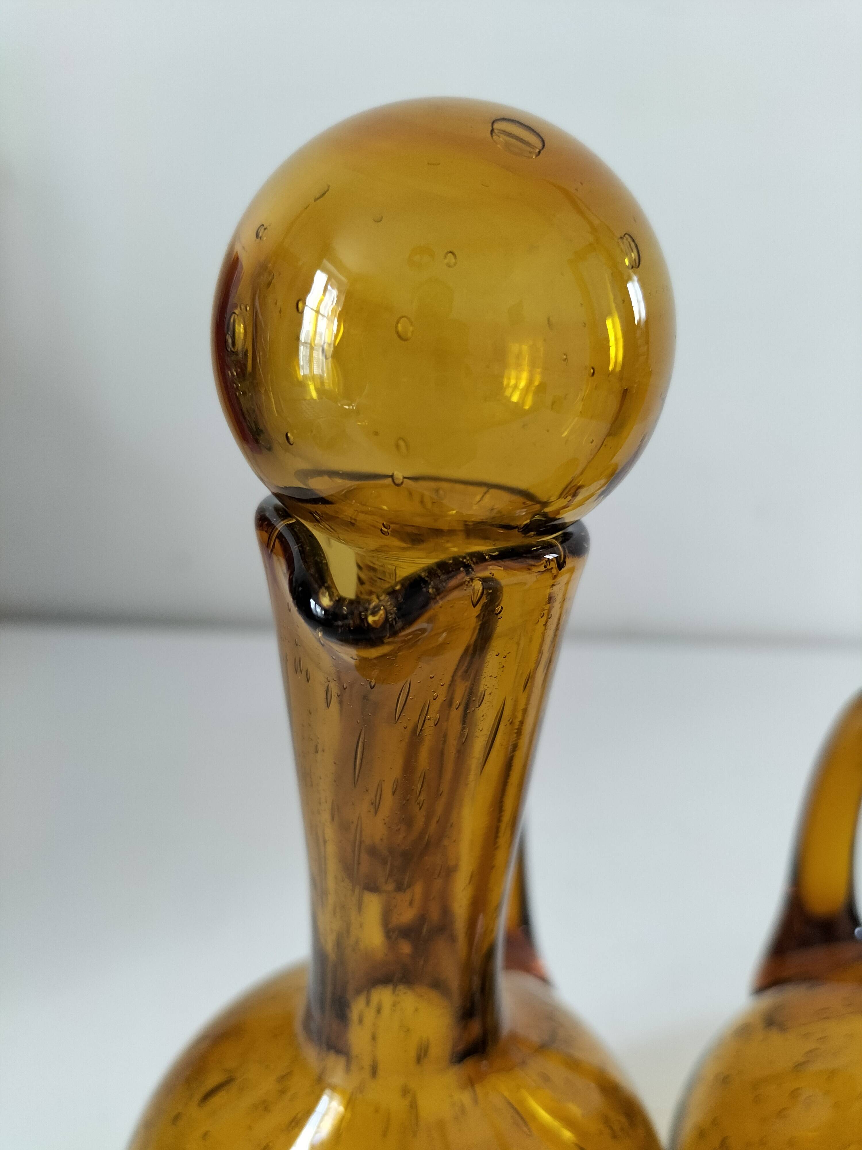 Duo of blown glass carafes – Biot signed – Bubbled amber glass