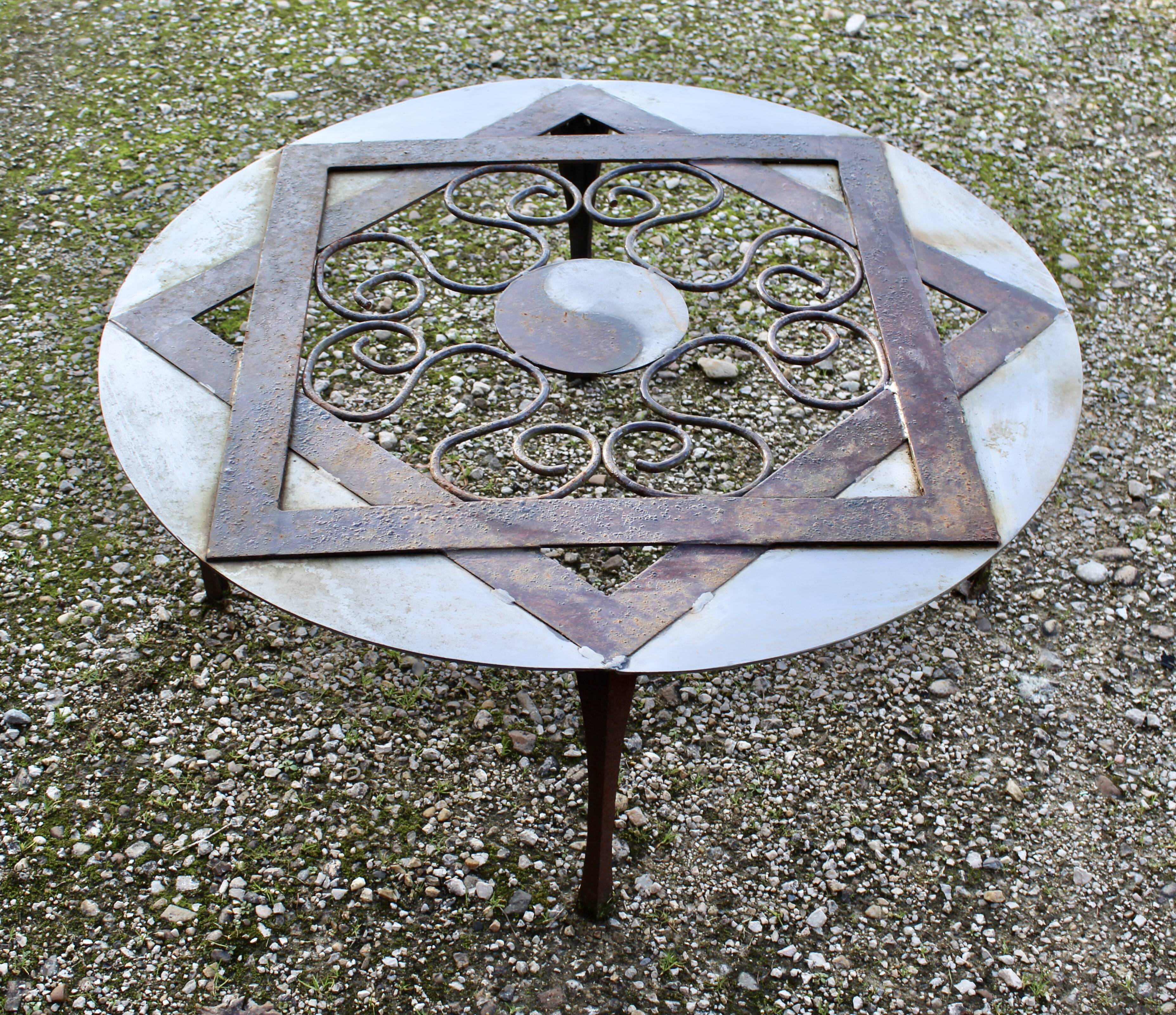 Outdoor iron table with yin yang decoration
