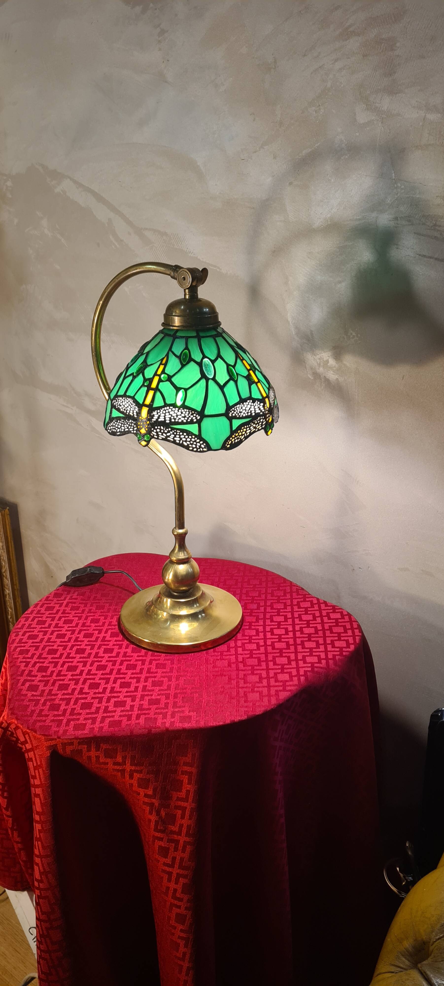 brass lamp with green stained glass shade.