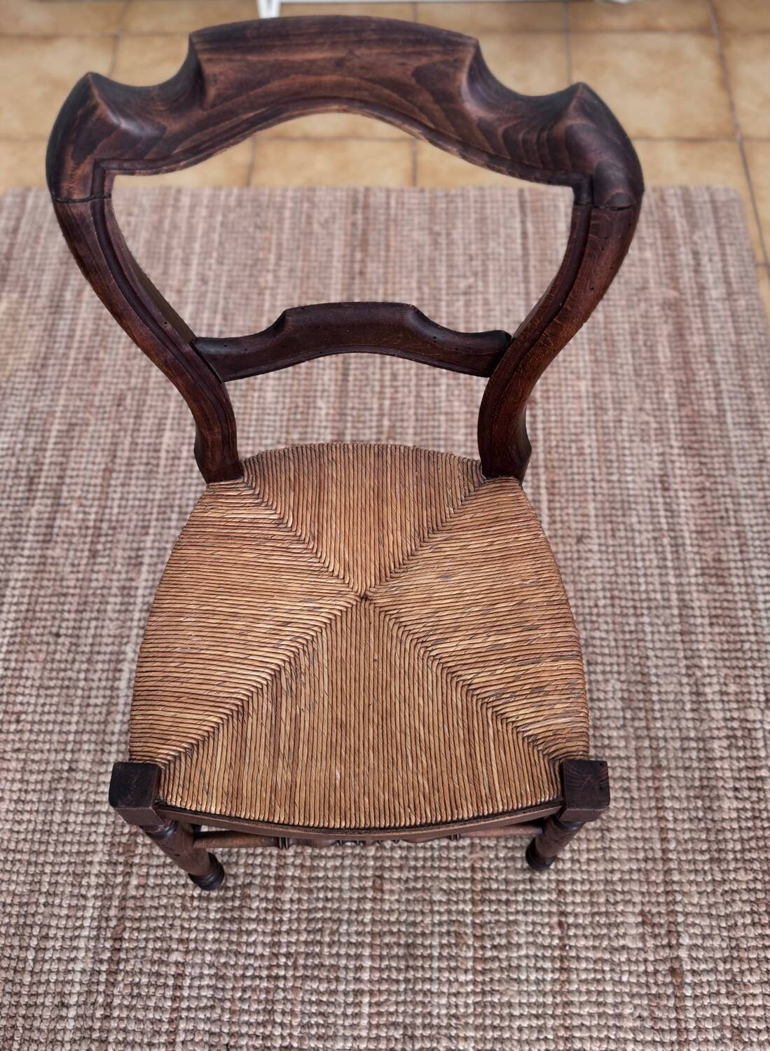 Antique wooden chairs with rush seating.