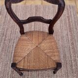 Antique wooden chairs with rush seating.