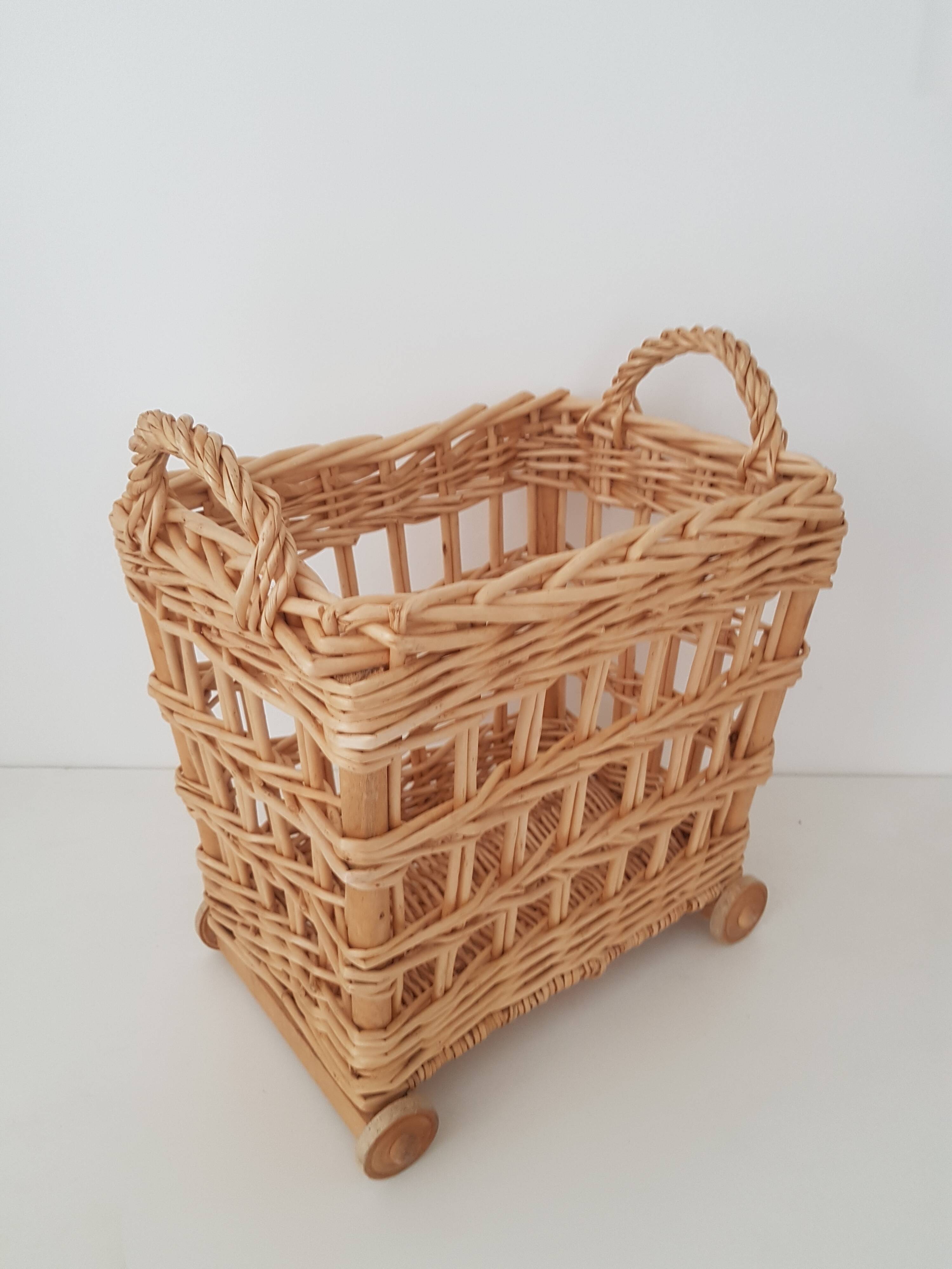 Vintage wicker basket on wheels - children's toy trolley