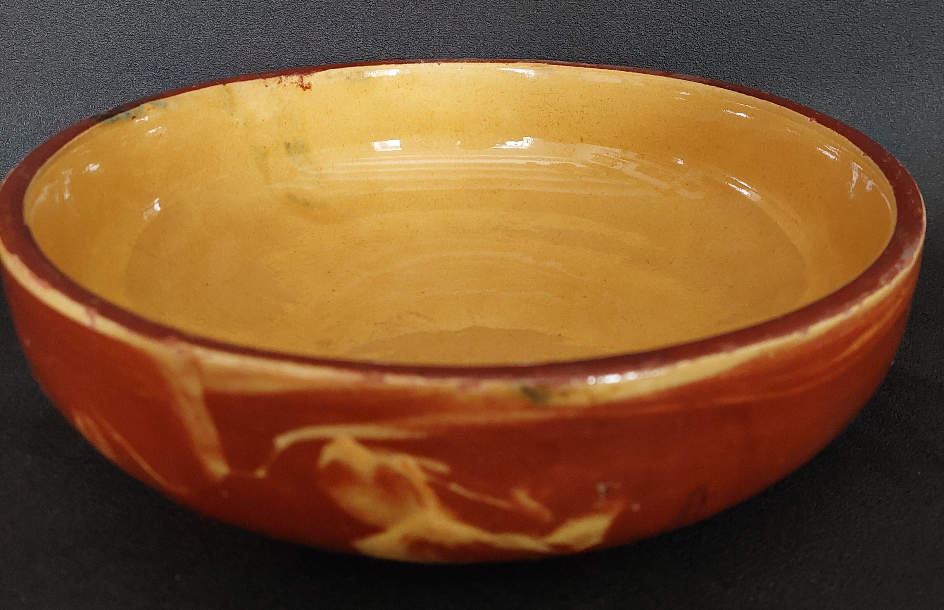 Glazed terracotta shallow dish from the 20th century.