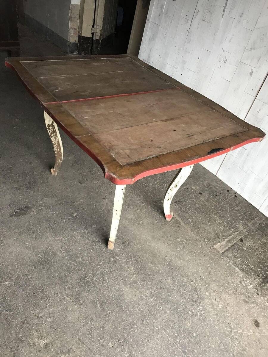 Rustic red and cream wooden dining table, moulded top, 1950s.