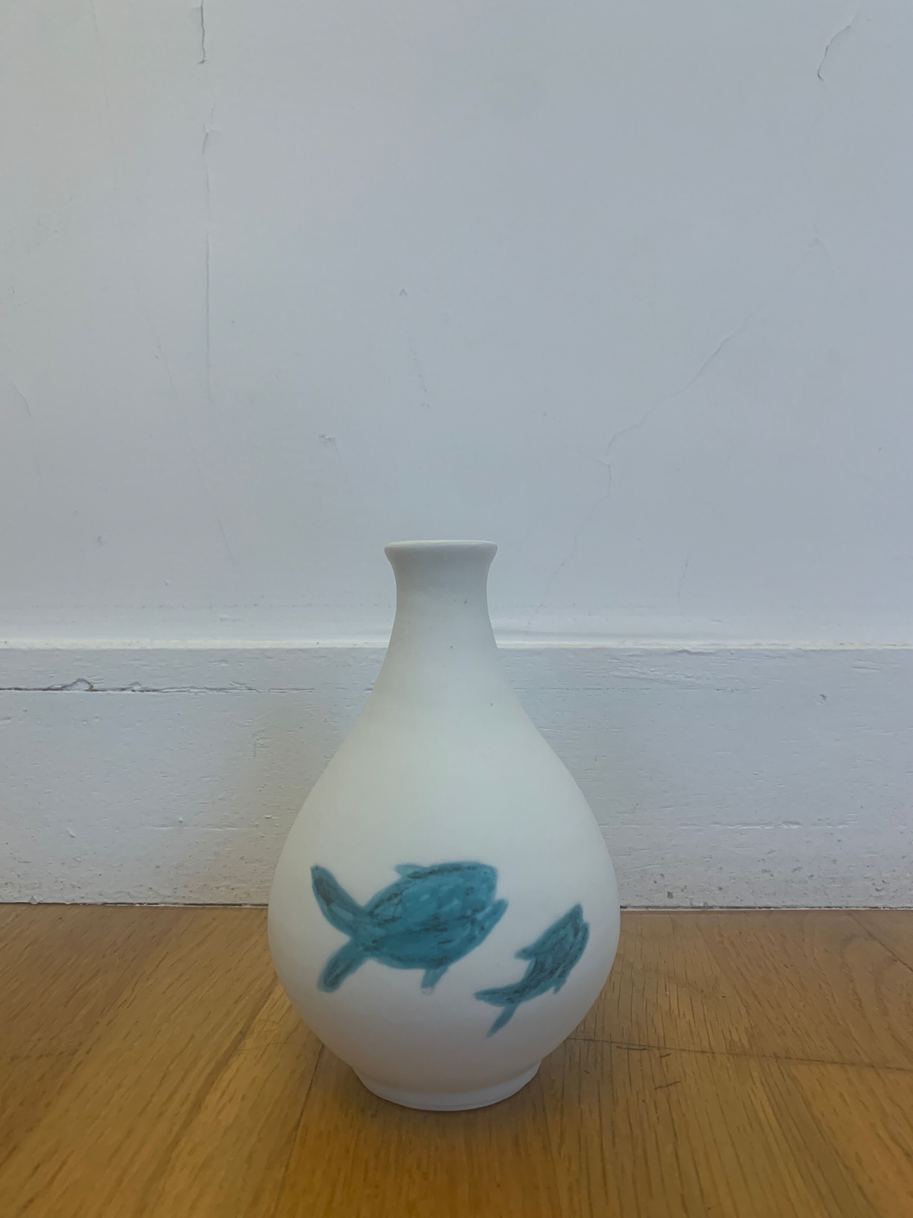 White ceramic with dolphin motif