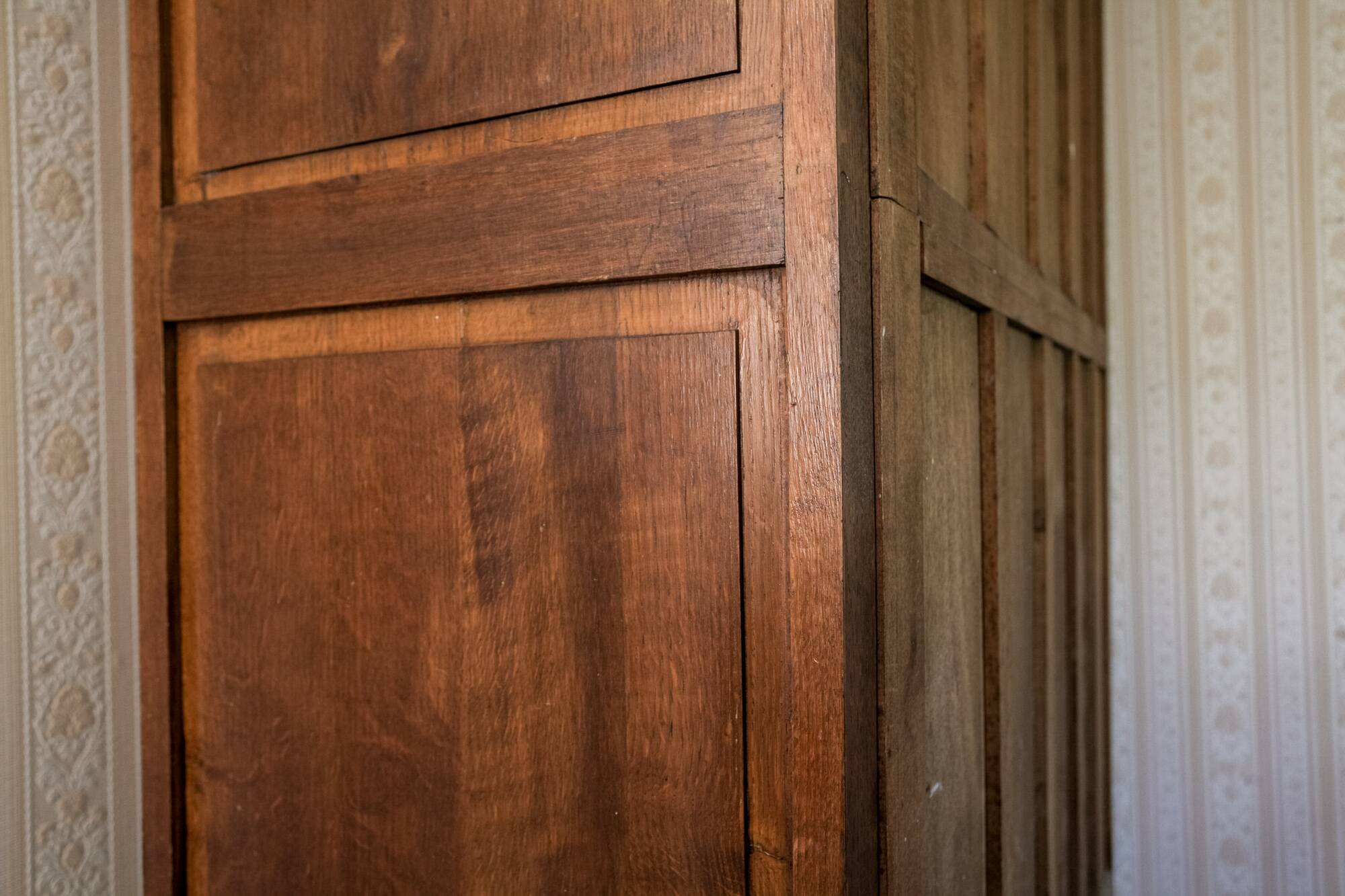 Old solid wood wardrobe with three vintage mirror doors