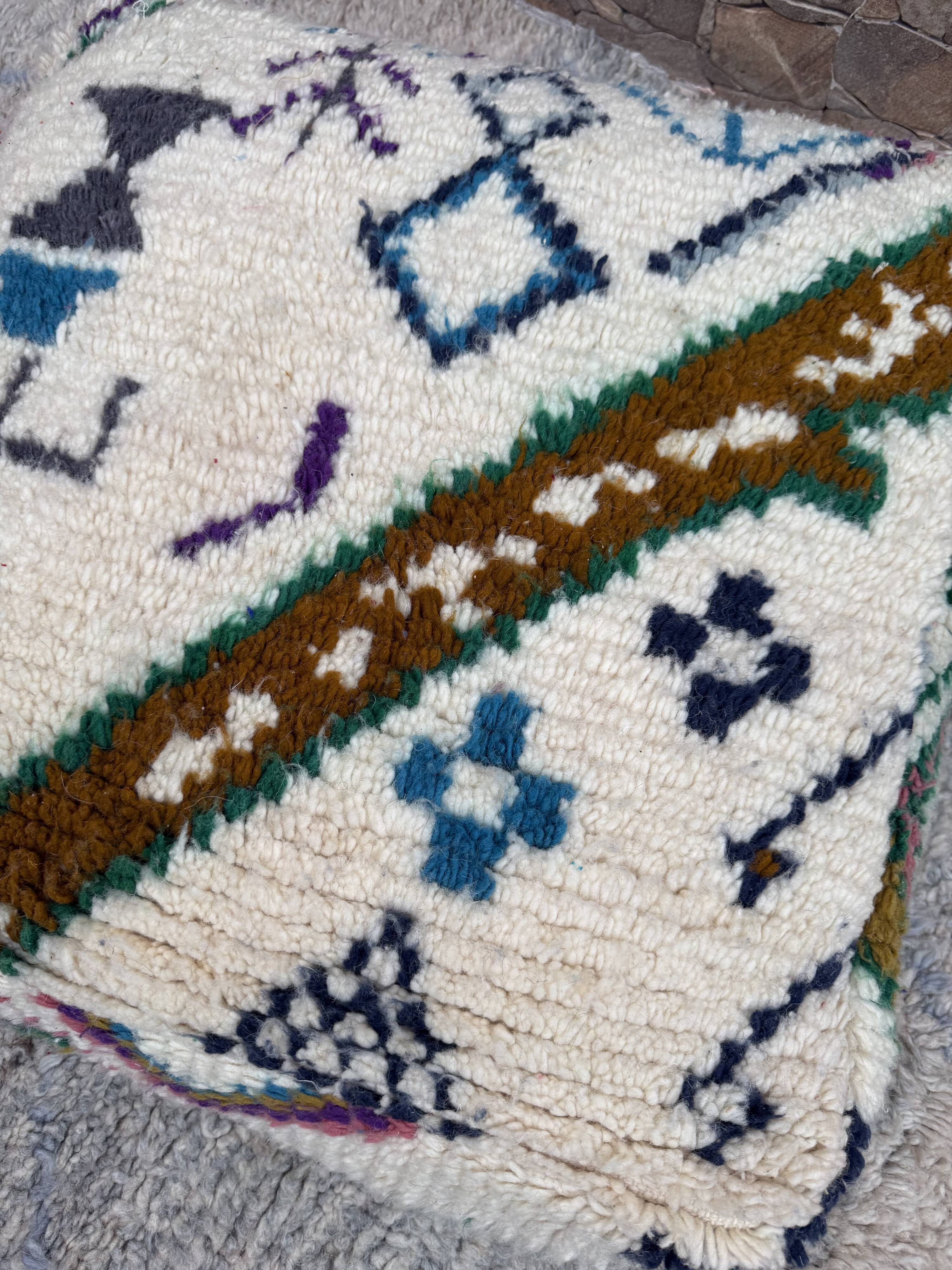 Berber floor pouf: Handwoven Moroccan wool cushion.