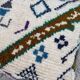 Berber floor pouf: Handwoven Moroccan wool cushion.