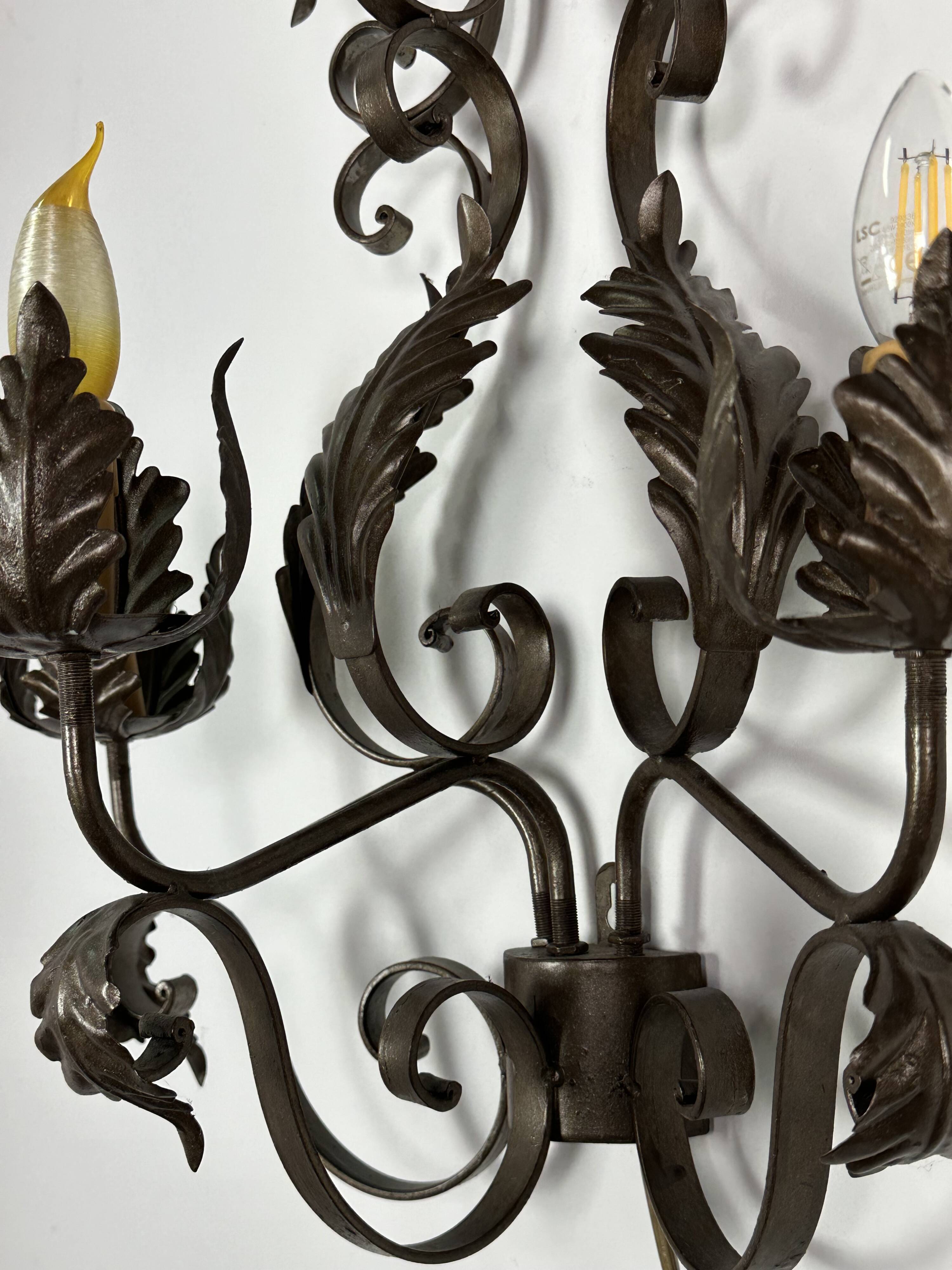 Wrought iron wall lights (pair) with foliage decoration