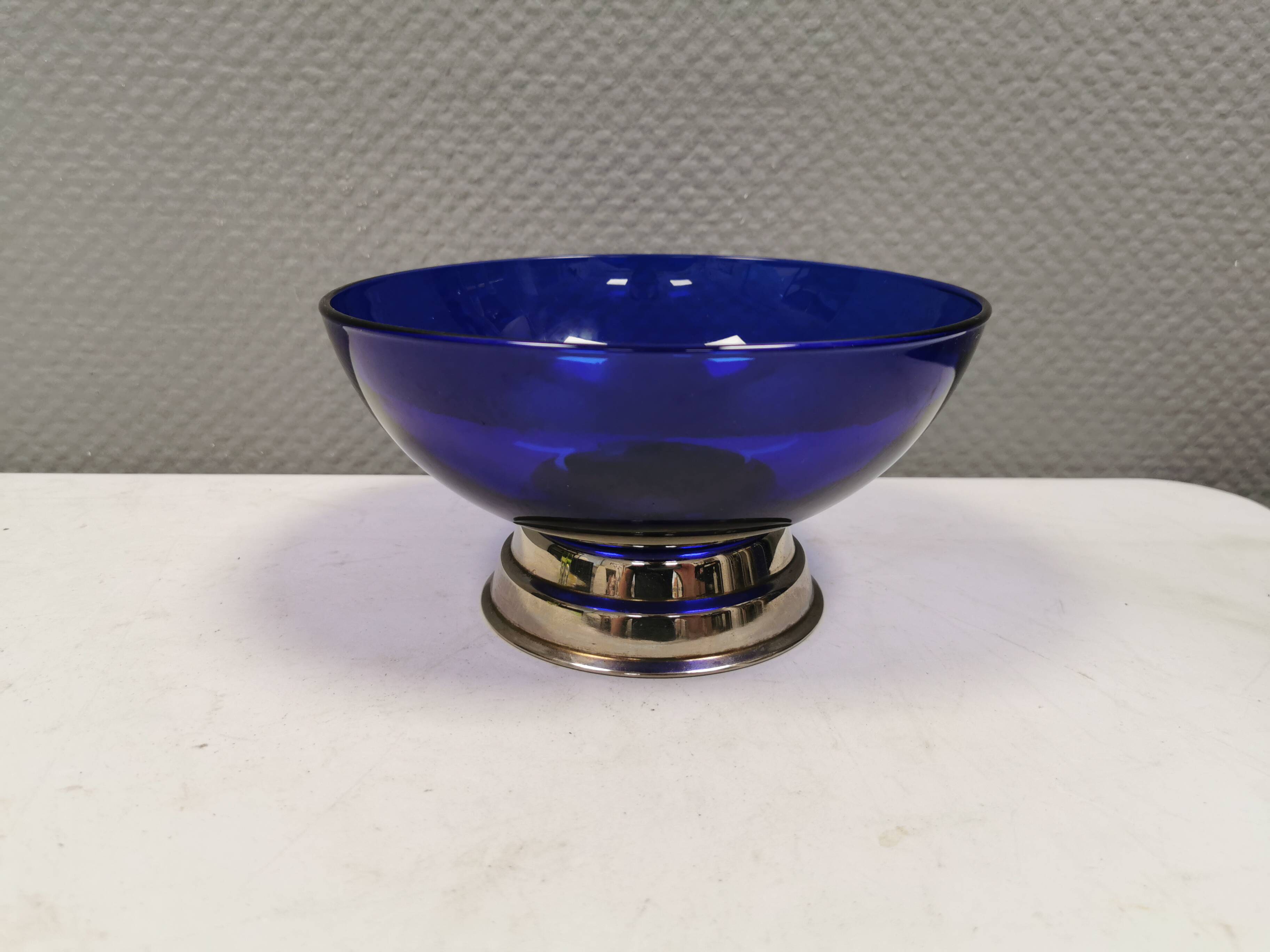 Beautiful blue glass bowl mounted on silver colored base (Original).