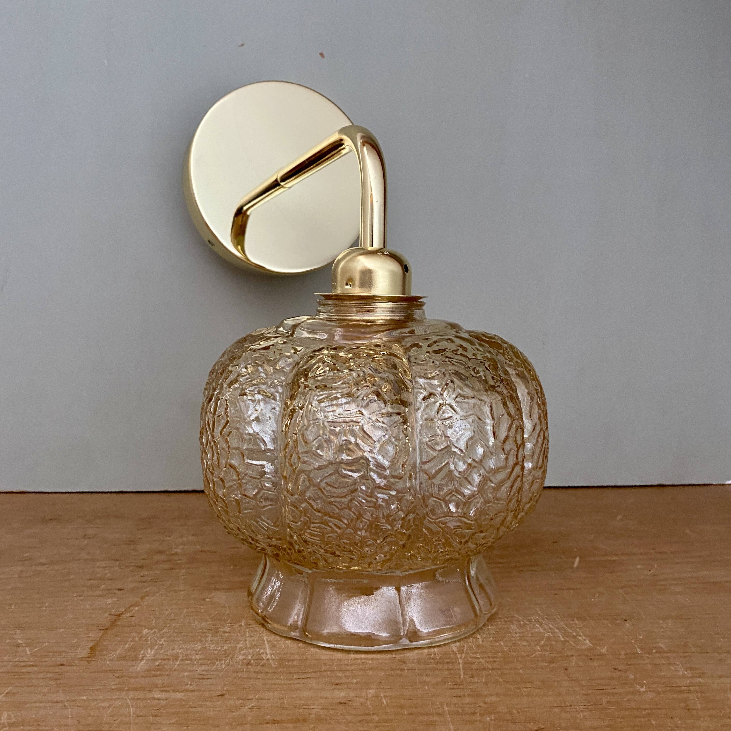 Vintage golden globe angled wall light in amber glass