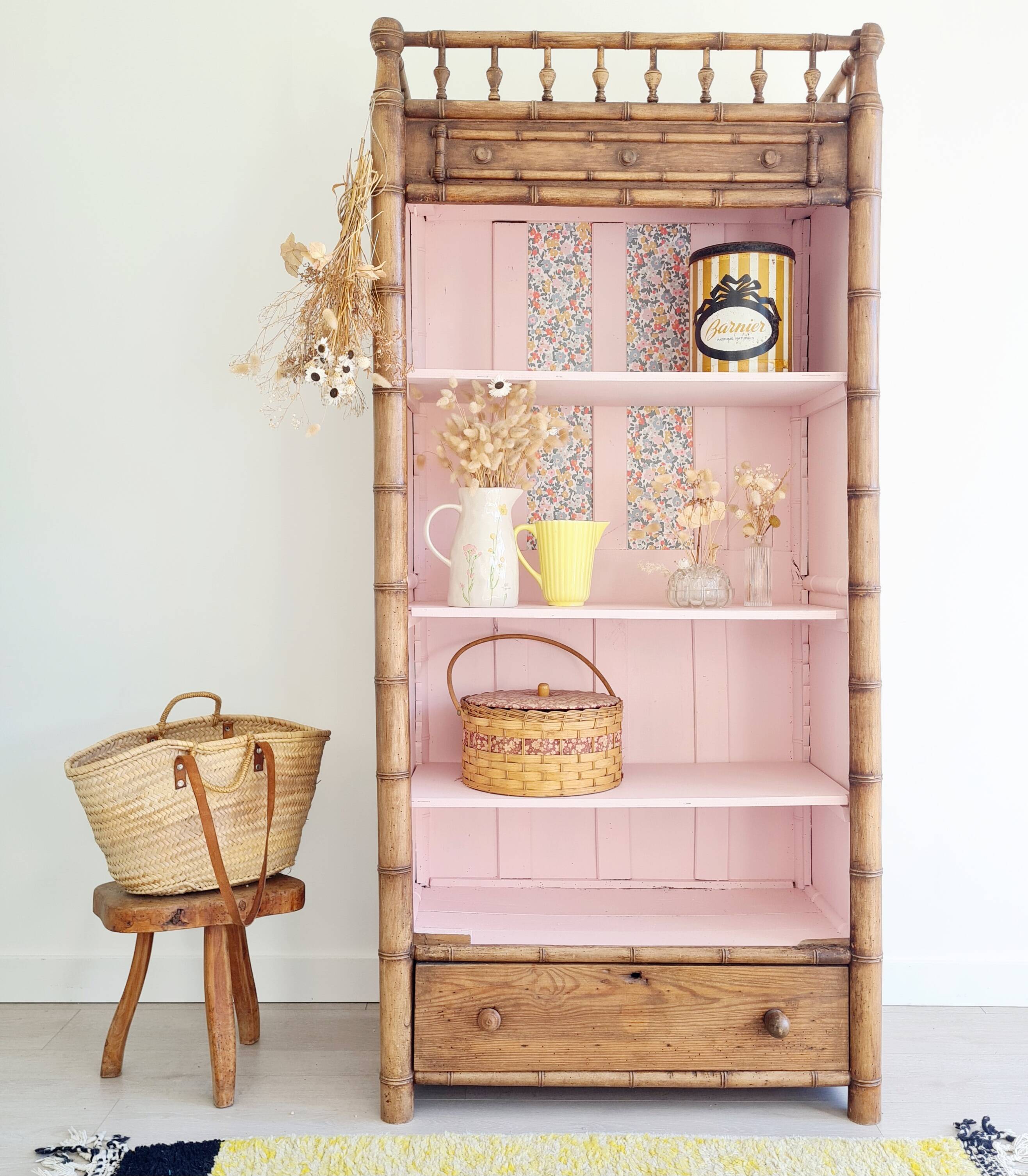 Library, old wooden cabinet imitating bamboo painted in pink