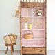 Library, old wooden cabinet imitating bamboo painted in pink