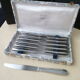 Box of 12 one-piece stainless steel table knives