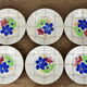 Lot de 12 assiettes motif fleurs de champagne.