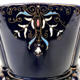 Large earthenware pot cover with enamelled decoration on a blue oven background