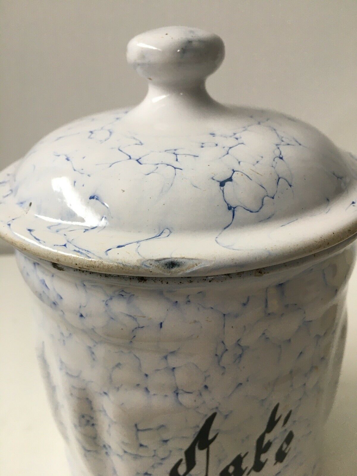 Vintage coffee pot in white enamelled iron and blue retro kitchen decoration