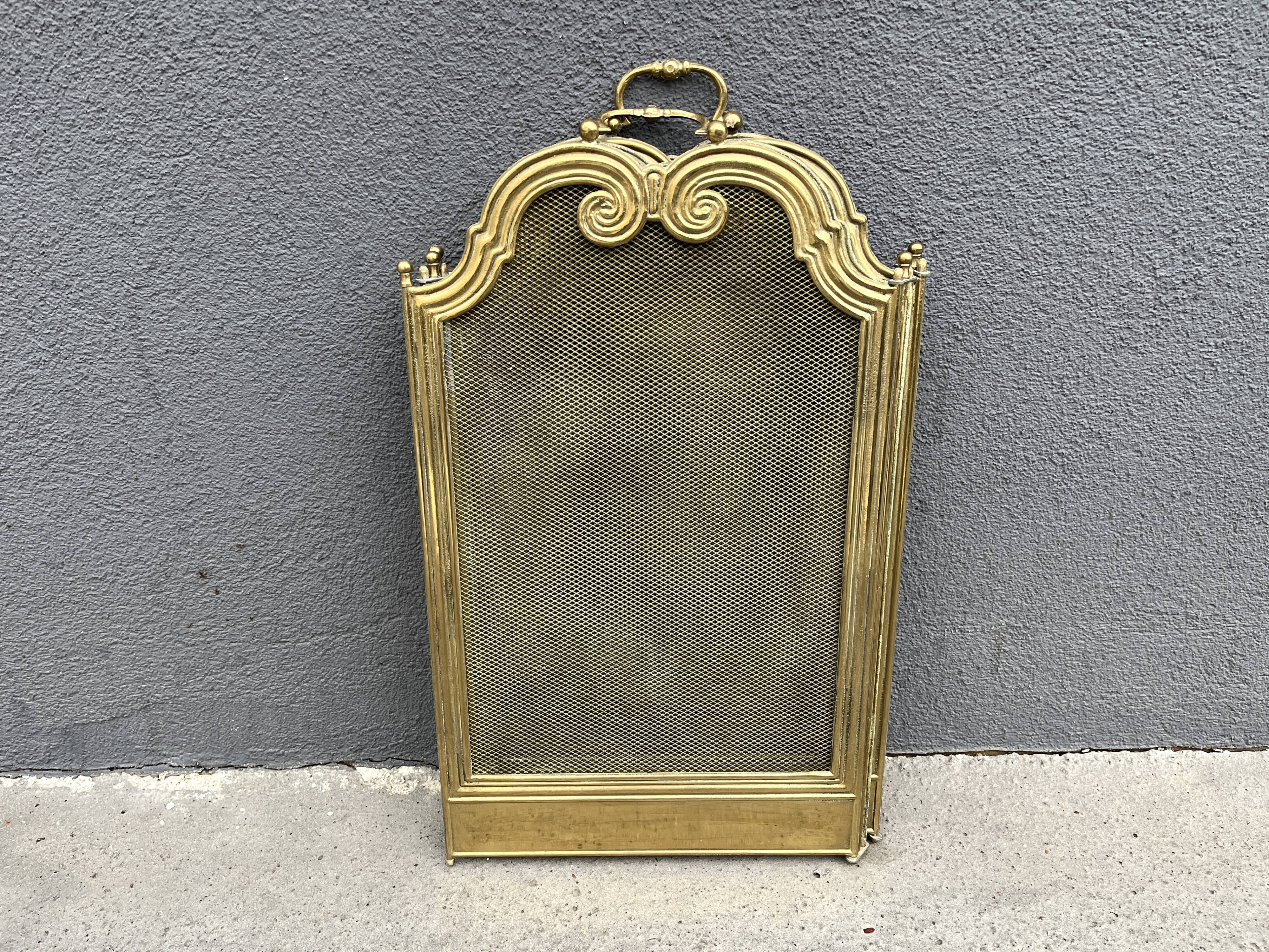 Antique brass fireplace screen from 1920, vintage spark guard.