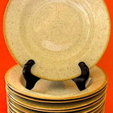 Suite of twelve speckled sandstone soup plates