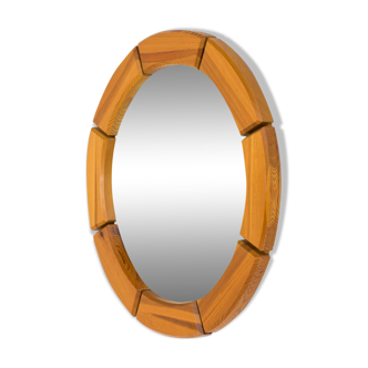 Sculptural wall-mirror in solid pine