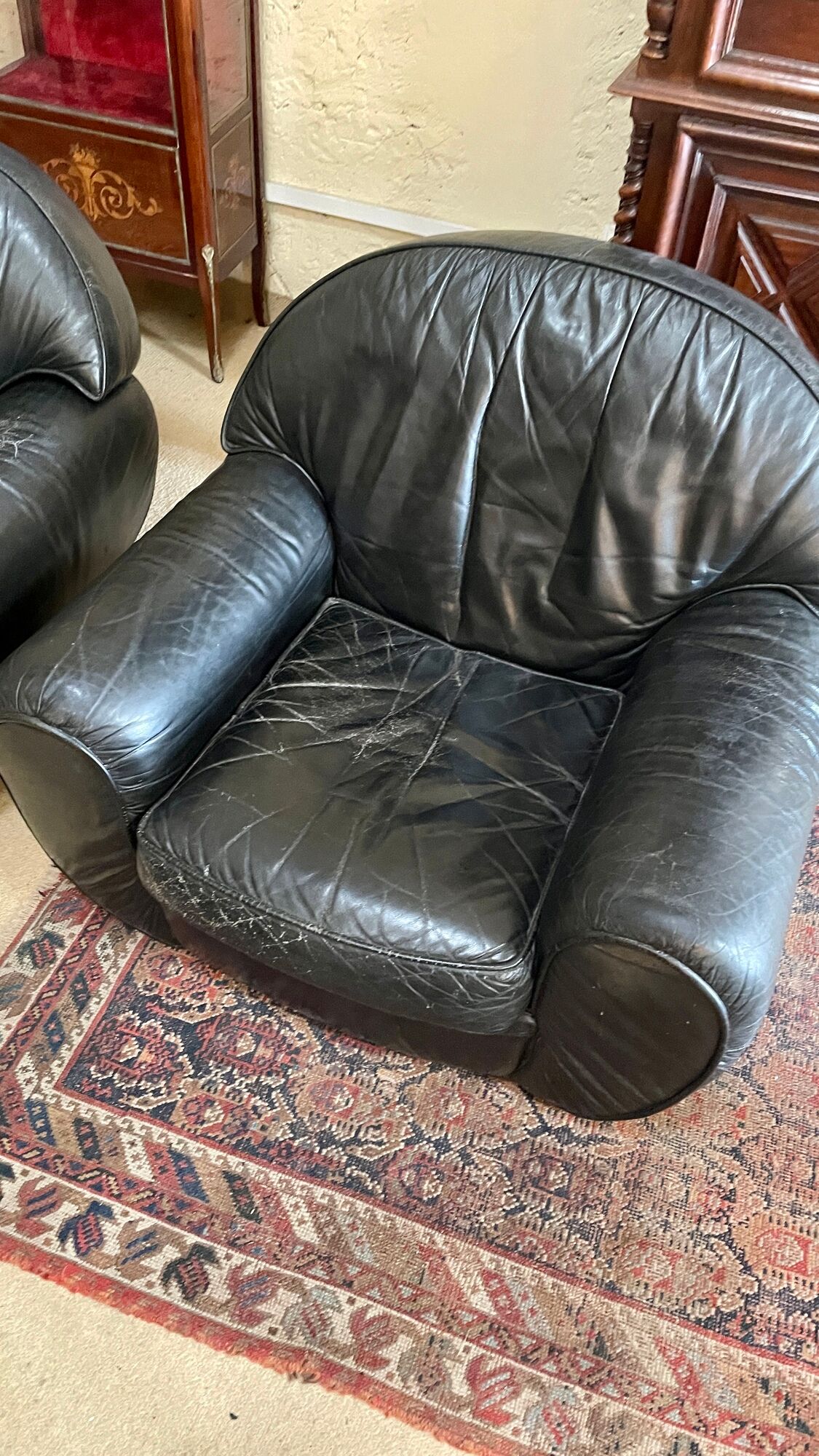 Pair of black leather club armchairs, twentieth century