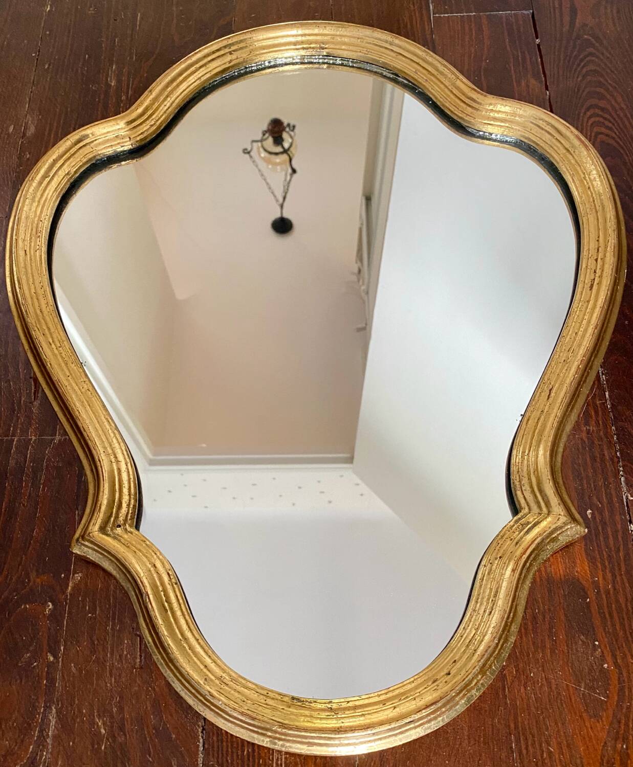 Wall mirror in a gilded wooden frame