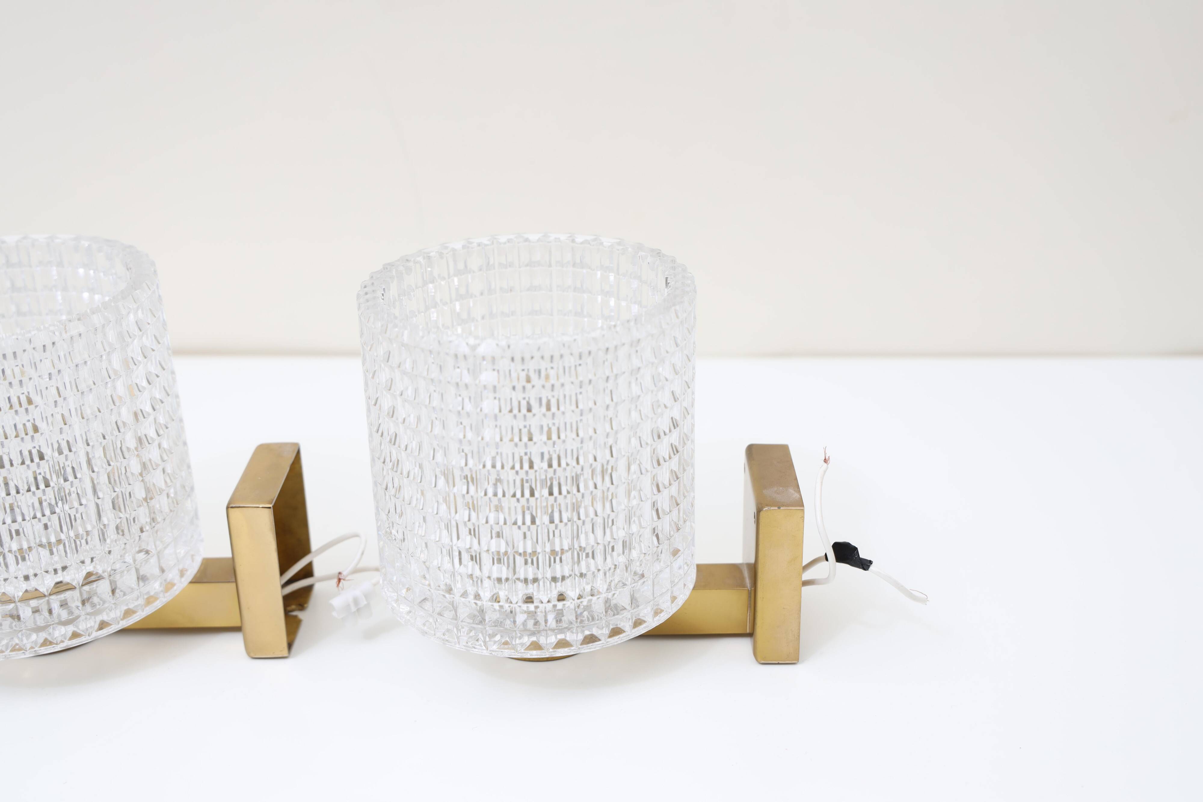 Carl Fagerlund for Orrefors Pair of wall lights in brass and glass Sweden 1960