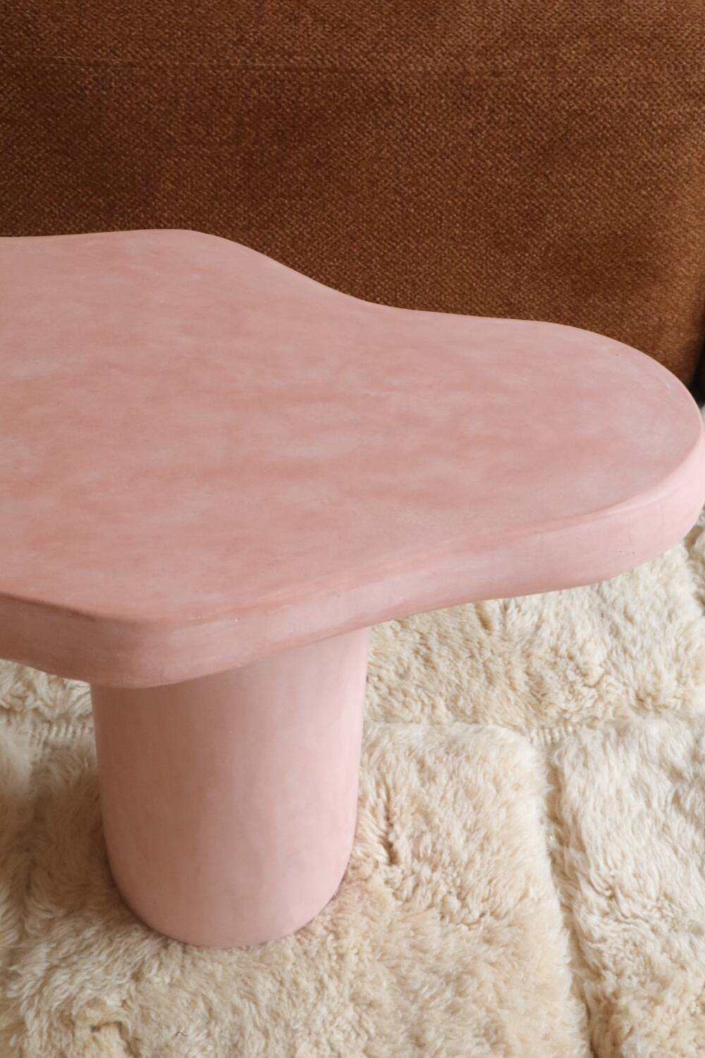 Organic shaped coffee table in pink teracotta tadelakt