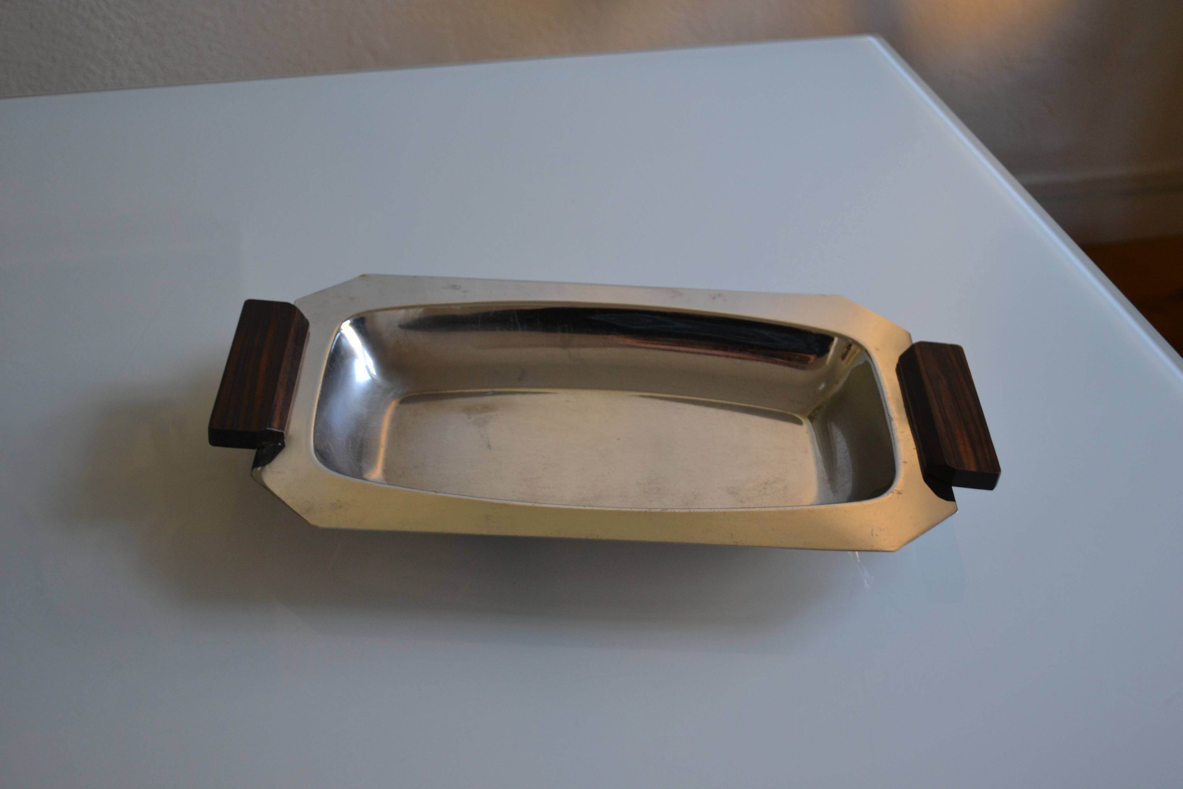 Art Deco serving dish in chrome metal with ebony handles.