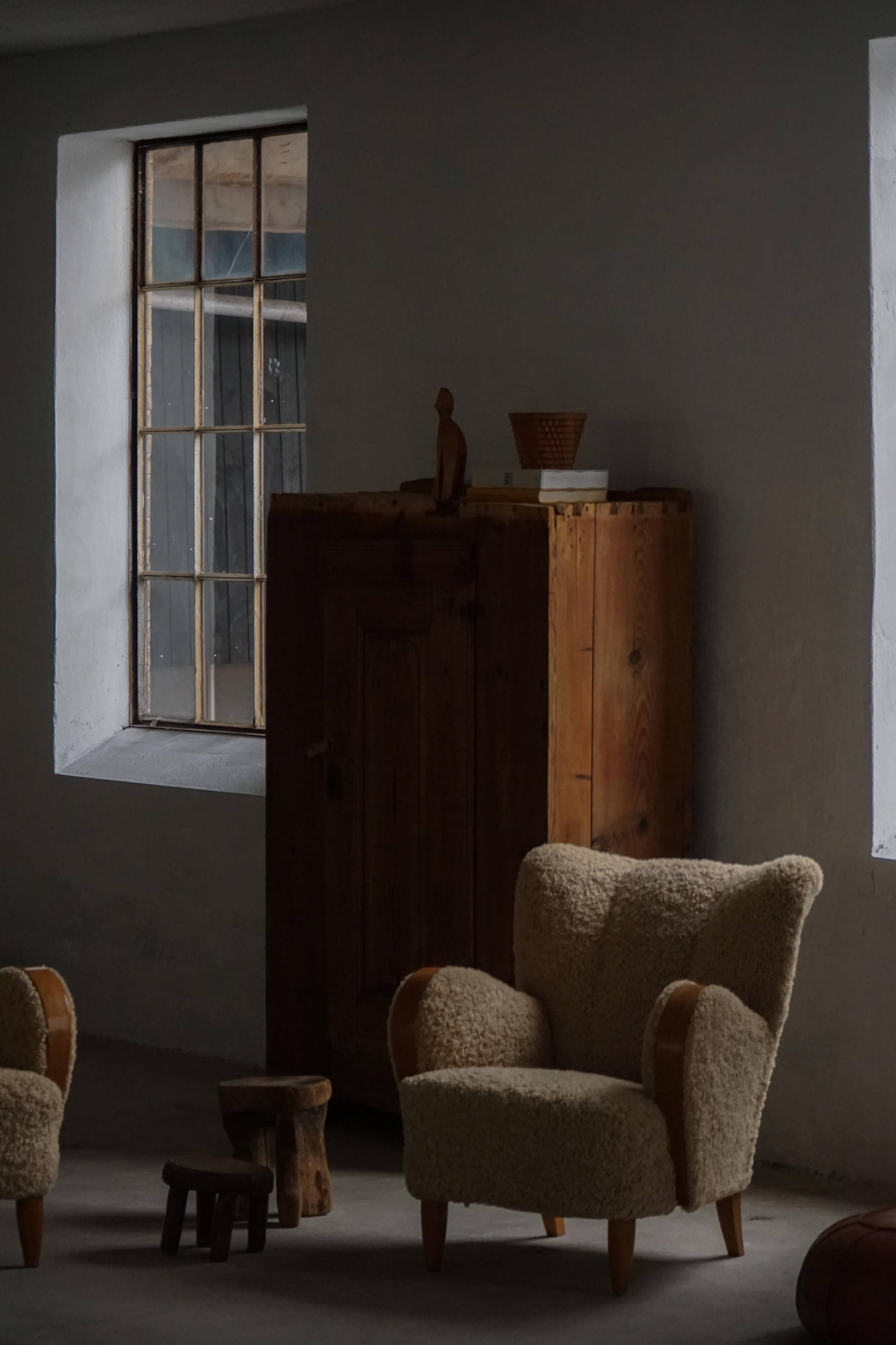Pair of Danish Art Deco modern lounge chairs in sheepskin with lambswool and elm, 1940s.
