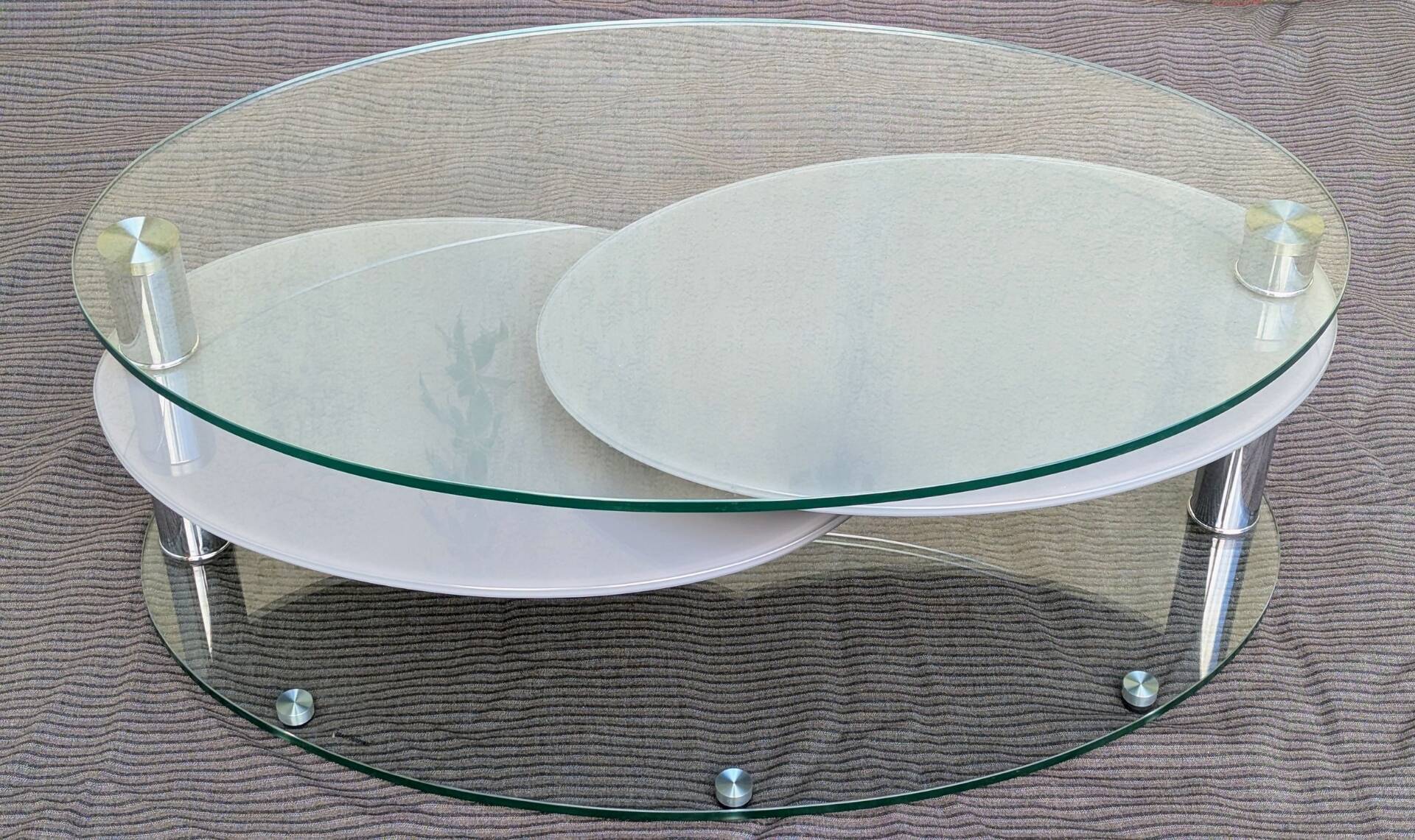 Coffee table with rotating glass tops by Antoine Motard.