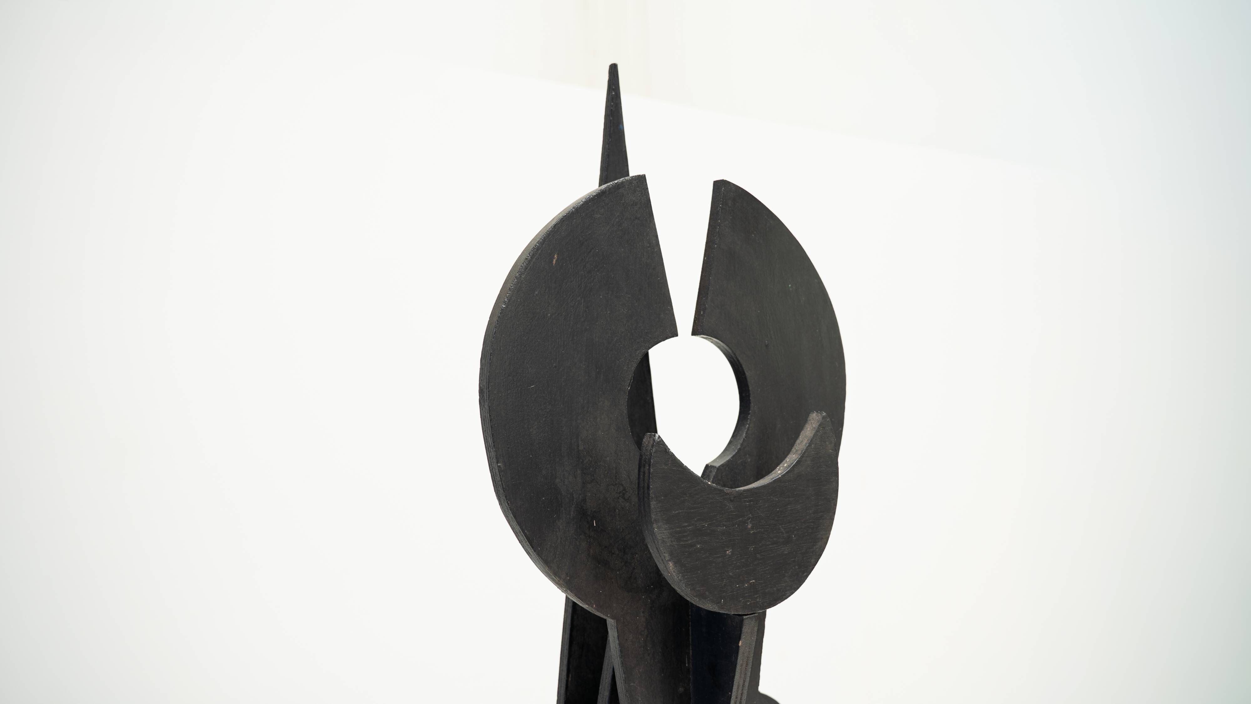 Black brutalist wooden sculpture